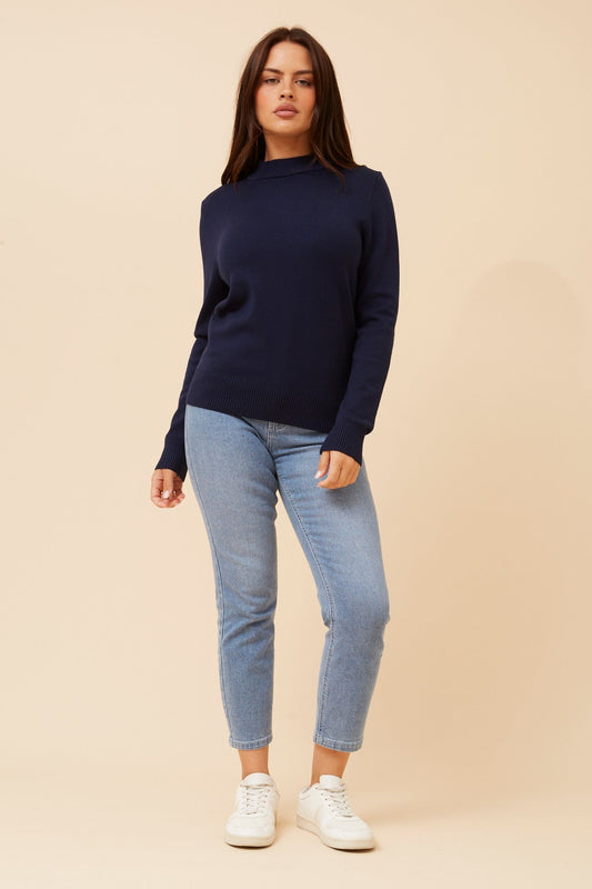Image of a model wearing Tops. Product name - PETUNIA TURTLE NECK KNIT PULLOVER in Navy colour by brand - Caroline Morgan Australia