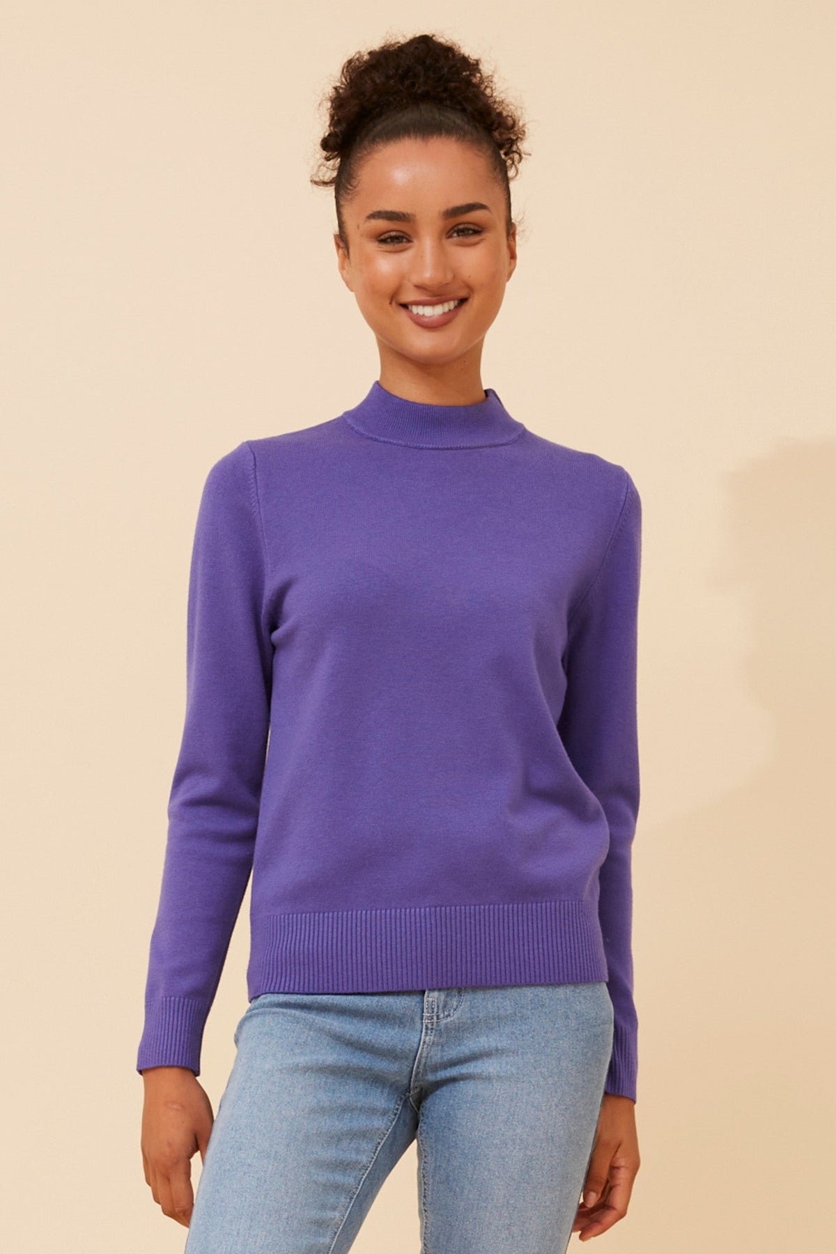 Image of a model wearing Tops. Product name - PETUNIA TURTLE NECK KNIT PULLOVER in Purple colour by brand - Caroline Morgan Australia