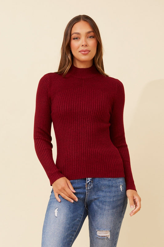 Image of a model wearing Outerwear. Product name - JUNE SOLID KNIT JUMPER in Red Pear colour by brand - Caroline Morgan Australia