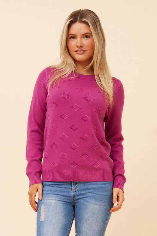 Image of a model wearing Outerwear. Product name - ANGIE DIAMOND PATTERN KNIT PULLOVER in Orchid colour by brand - Caroline Morgan Australia