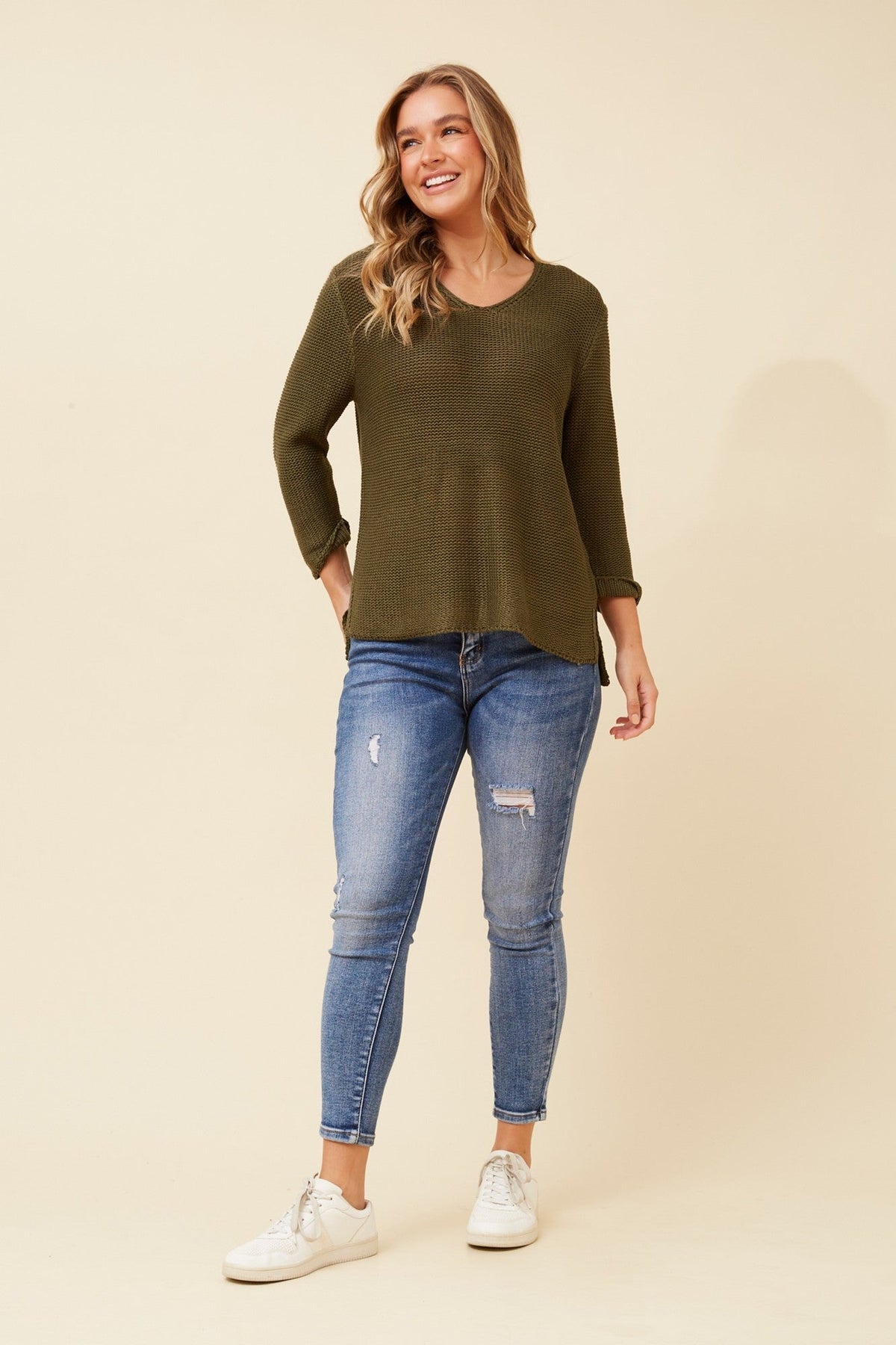 Image of a model wearing Outerwear. Product name - ROHANA SOLID KNIT PULLOVER in Khaki colour by brand - Caroline Morgan Australia