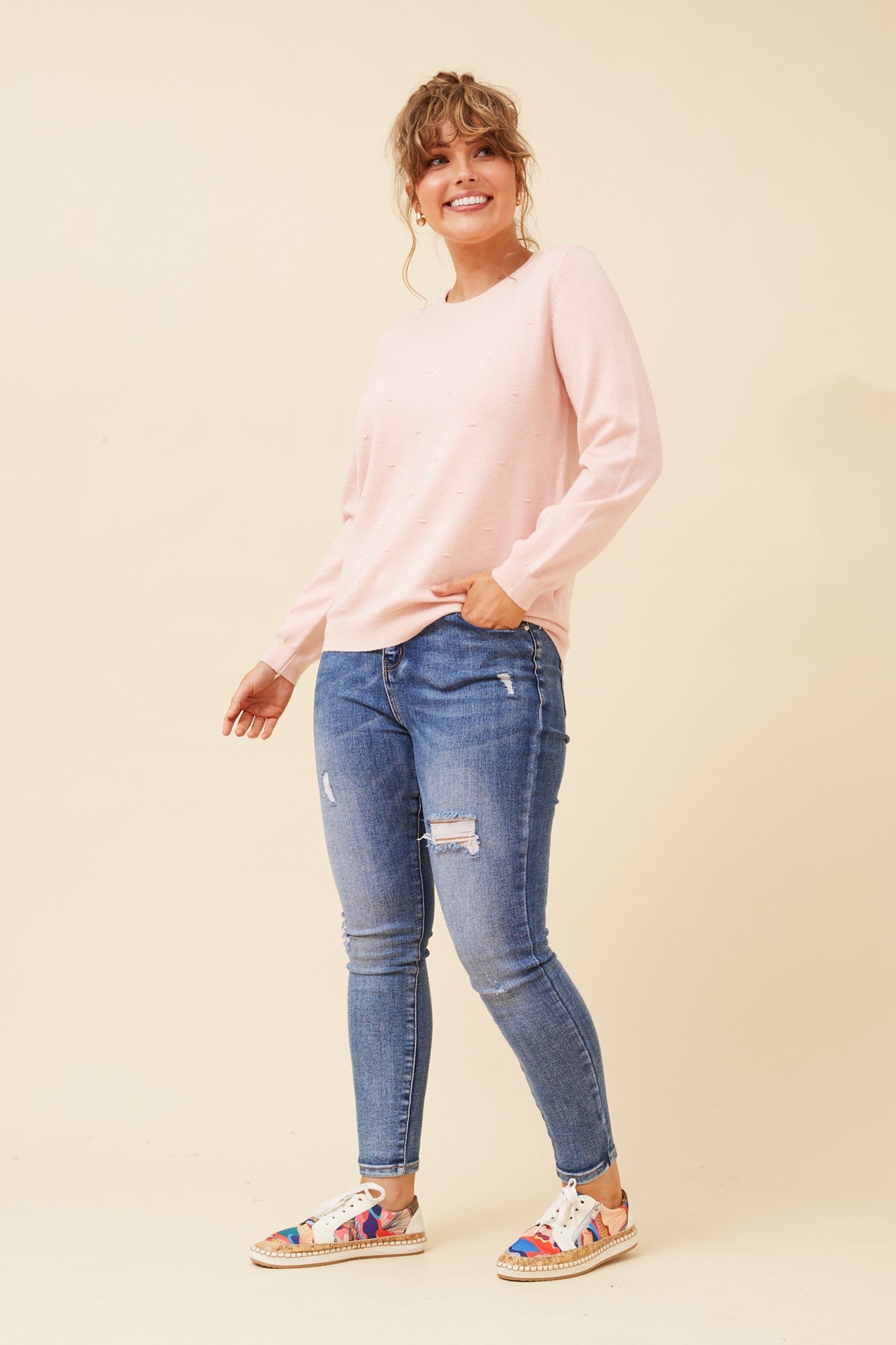 Image of a model wearing Outerwear. Product name - ANGIE POLKA DOT KNIT PULLOVER in Blush colour by brand - Caroline Morgan Australia