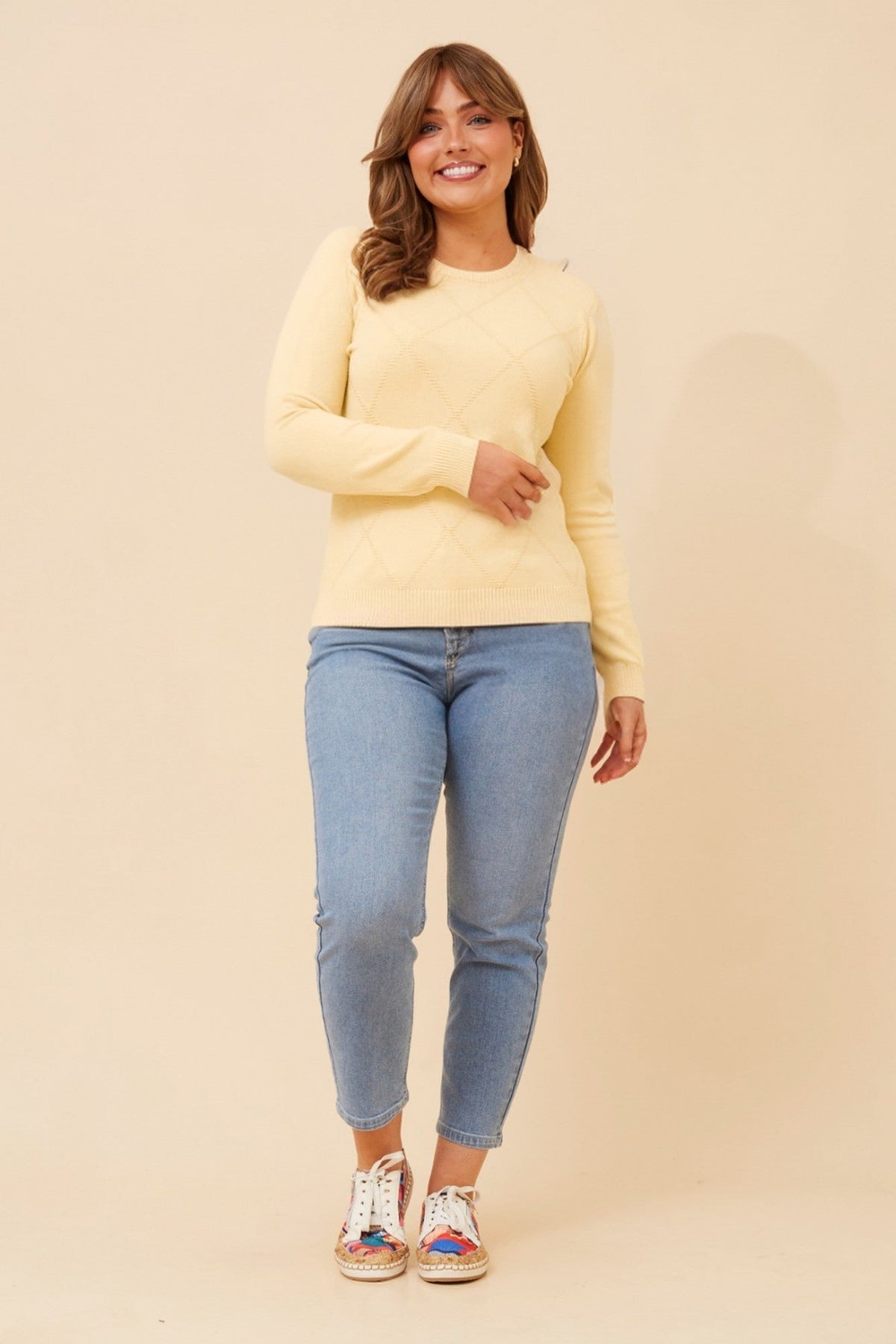 Image of a model wearing Outerwear. Product name - ANGIE DIAMOND PATTERN KNIT PULLOVER in Black colour by brand - Caroline Morgan Australia