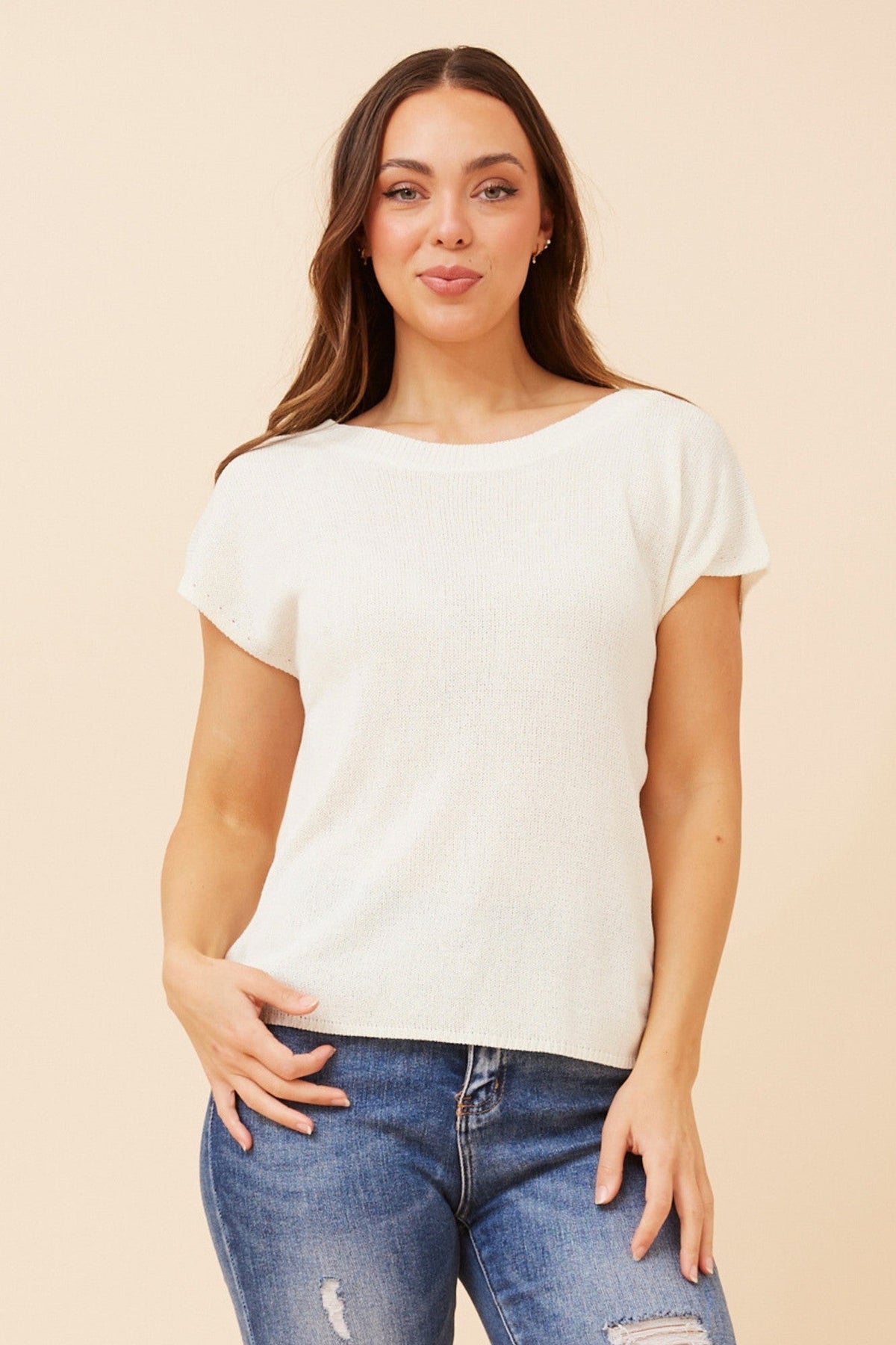 Image of a model wearing Tops. Product name - JOBETH SOLID KNIT TOP in White colour by brand - Caroline Morgan Australia