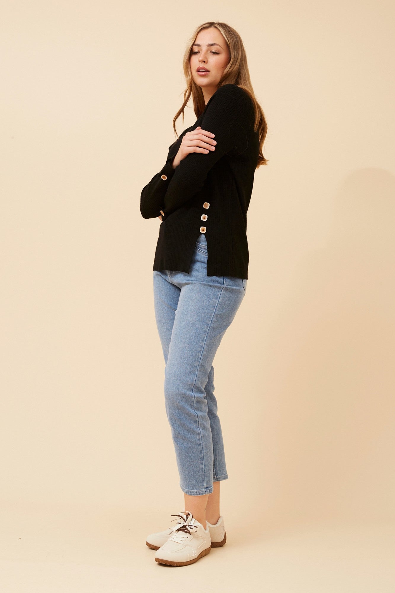 Image of a model wearing Outerwear. Product name - ANA SOLID KNIT PULLOVER in Black colour by brand - Caroline Morgan Australia