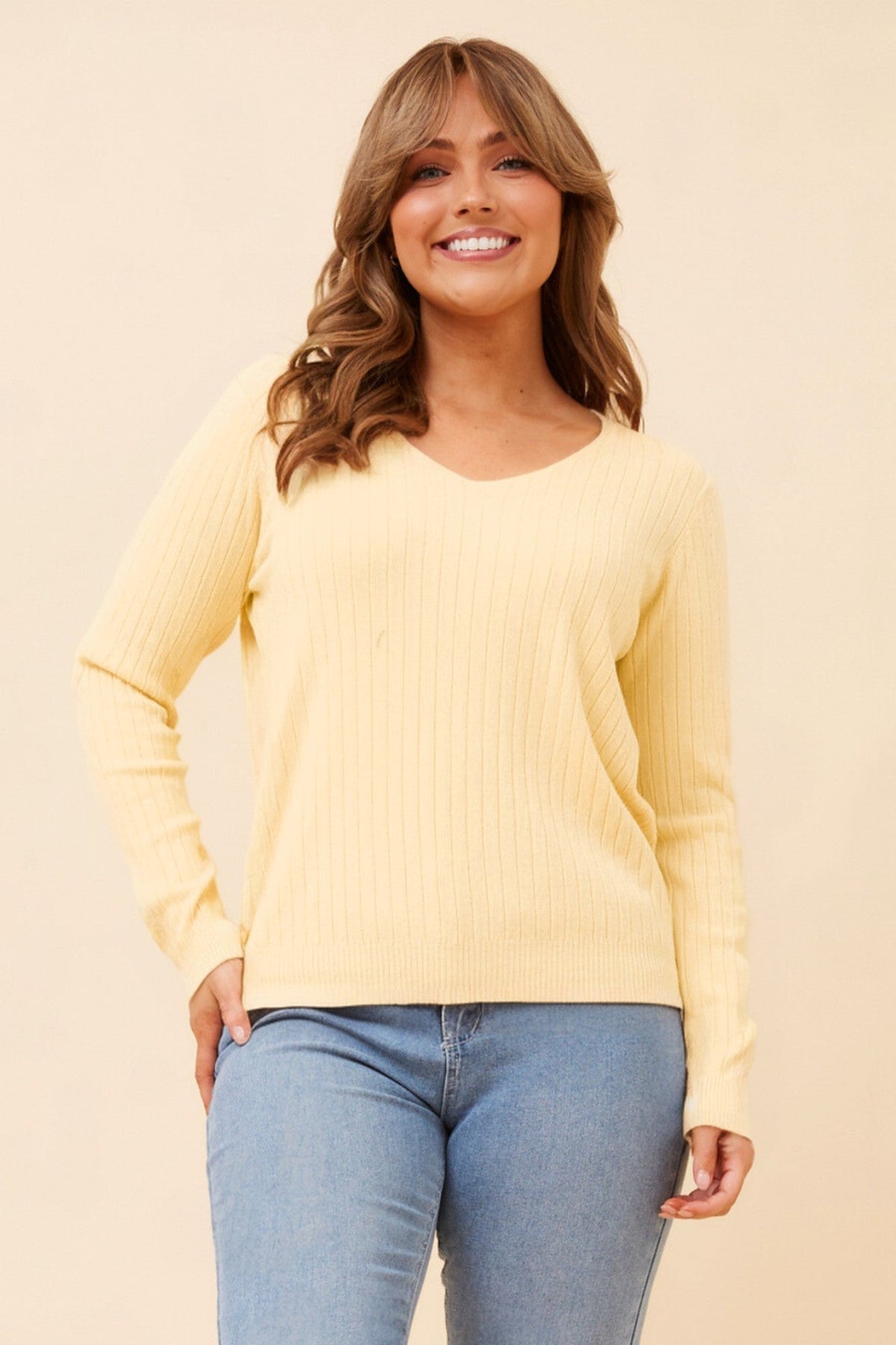 Image of a model wearing Outerwear. Product name - PAZ SOLID KNIT PULLOVER in Lemon colour by brand - Caroline Morgan Australia