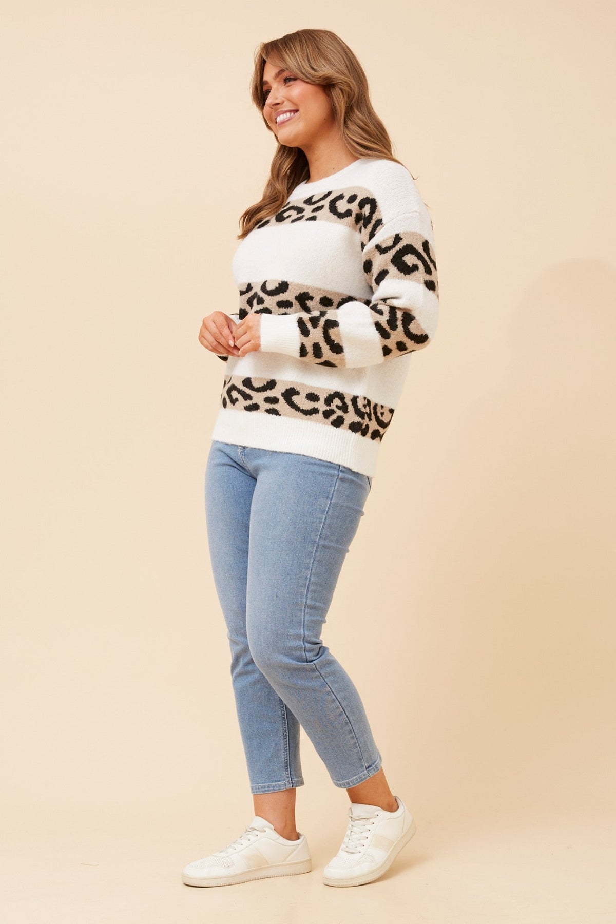 Image of a model wearing Outerwear. Product name - ZINAIDA ANIMAL PRINT KNIT PULLOVER in White colour by brand - Caroline Morgan Australia