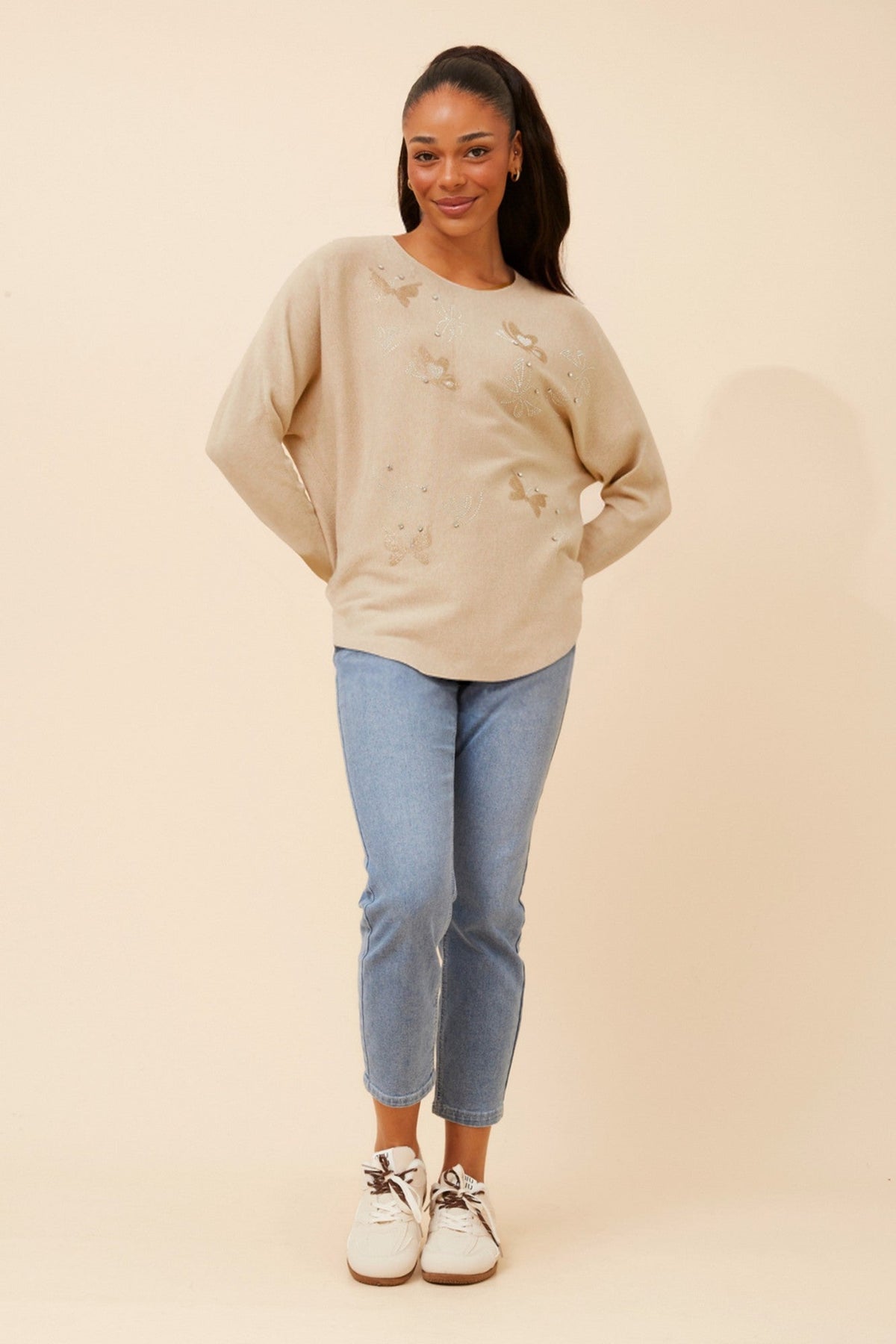 Image of a model wearing Outerwear. Product name - ASTI BUTTERFLY PRINT KNIT PULLOVER in Beige colour by brand - Caroline Morgan Australia