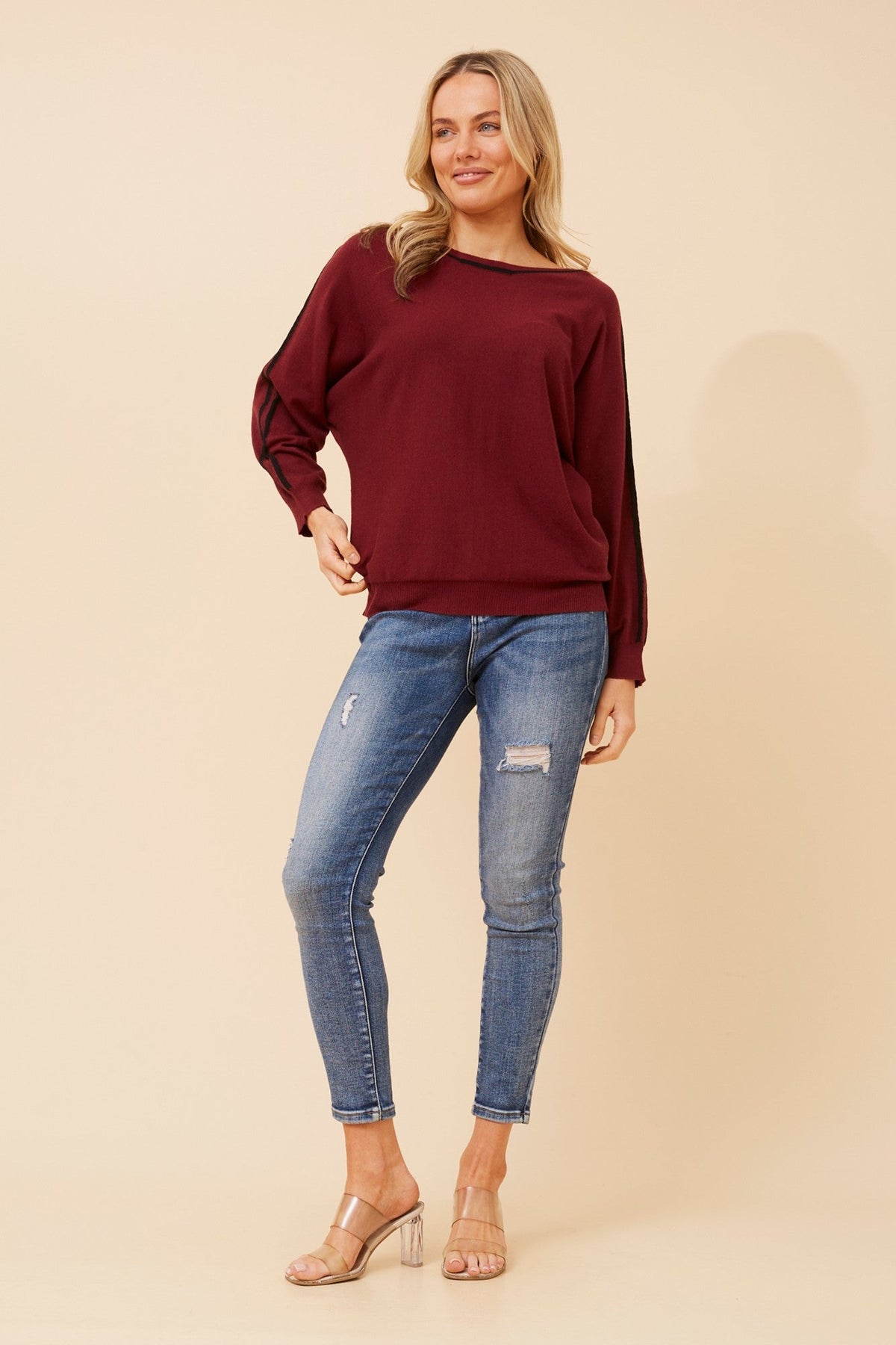 Image of a model wearing Outerwear. Product name - NELLY SOLID KNIT PULLOVER in Latte colour by brand - Caroline Morgan Australia