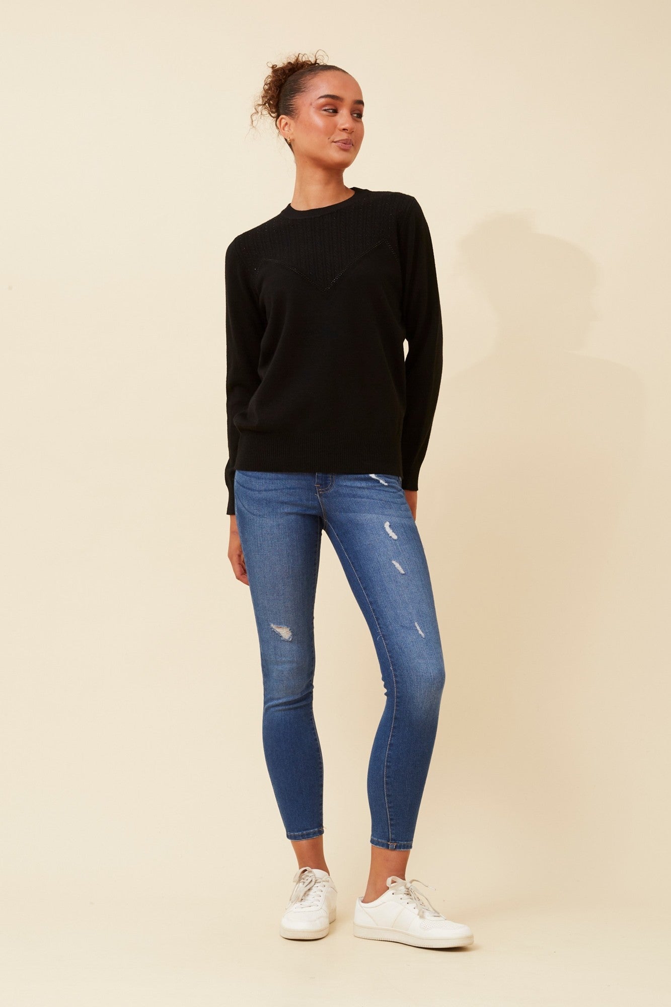 Image of a model wearing Outerwear. Product name - ANGIE DIAMANTE KNIT PULLOVER in Black colour by brand - Caroline Morgan Australia