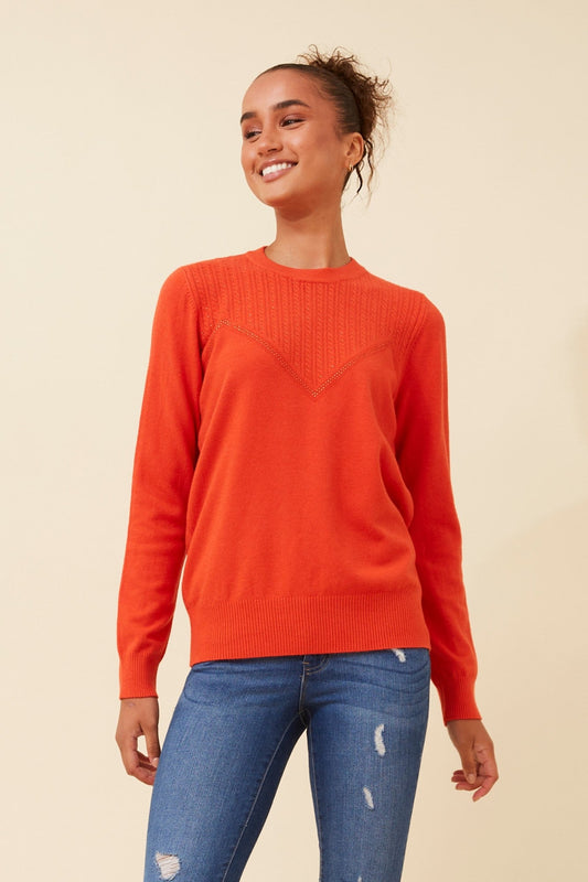 Image of a model wearing Outerwear. Product name - ANGIE DIAMANTE KNIT PULLOVER in Orange colour by brand - Caroline Morgan Australia