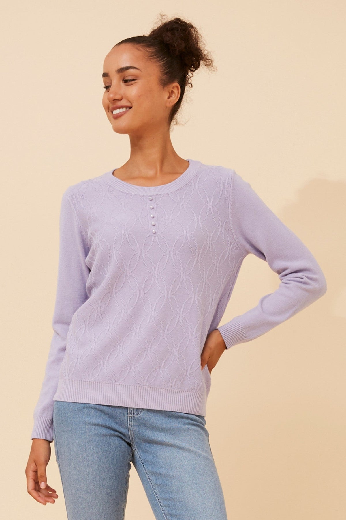 Image of a model wearing Outerwear. Product name - ANGIE PEARL EMBELLISHED KNIT JUMPER in Blue Jean colour by brand - Caroline Morgan Australia