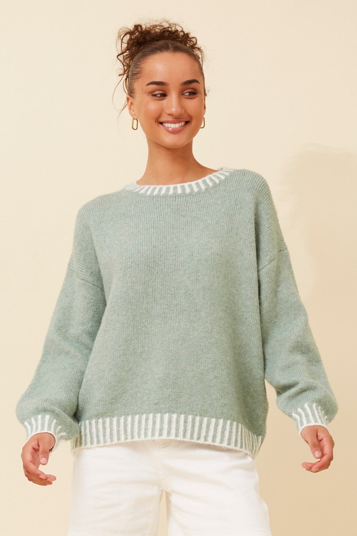 Image of a model wearing Outerwear. Product name - MAILANI SOLID KNIT PULLOVER in Cement colour by brand - Caroline Morgan Australia
