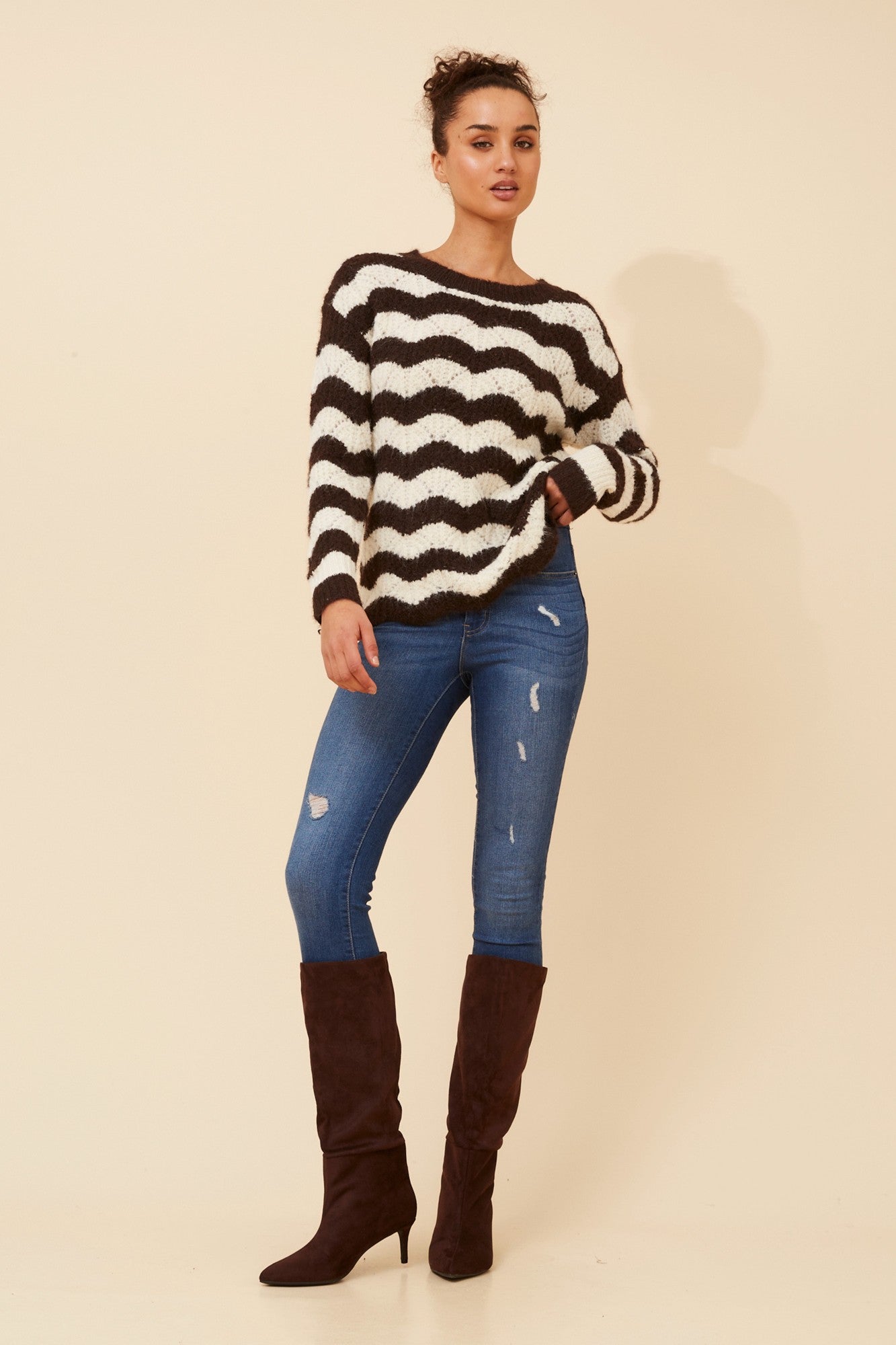 Image of a model wearing Outerwear. Product name - IVETTE STRIPE PRINT KNIT PULLOVER in Chocolate/Cream colour by brand - Caroline Morgan Australia