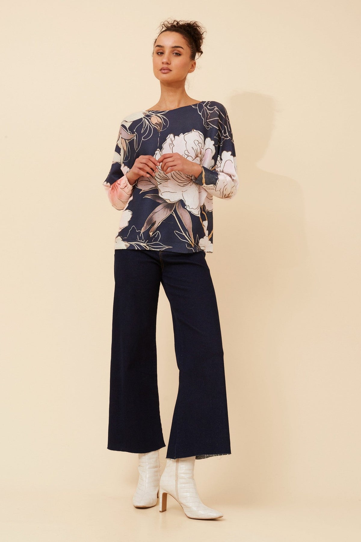 Image of a model wearing Outerwear. Product name - HENRI FLORAL PULLOVER in Navy colour by brand - Caroline Morgan Australia