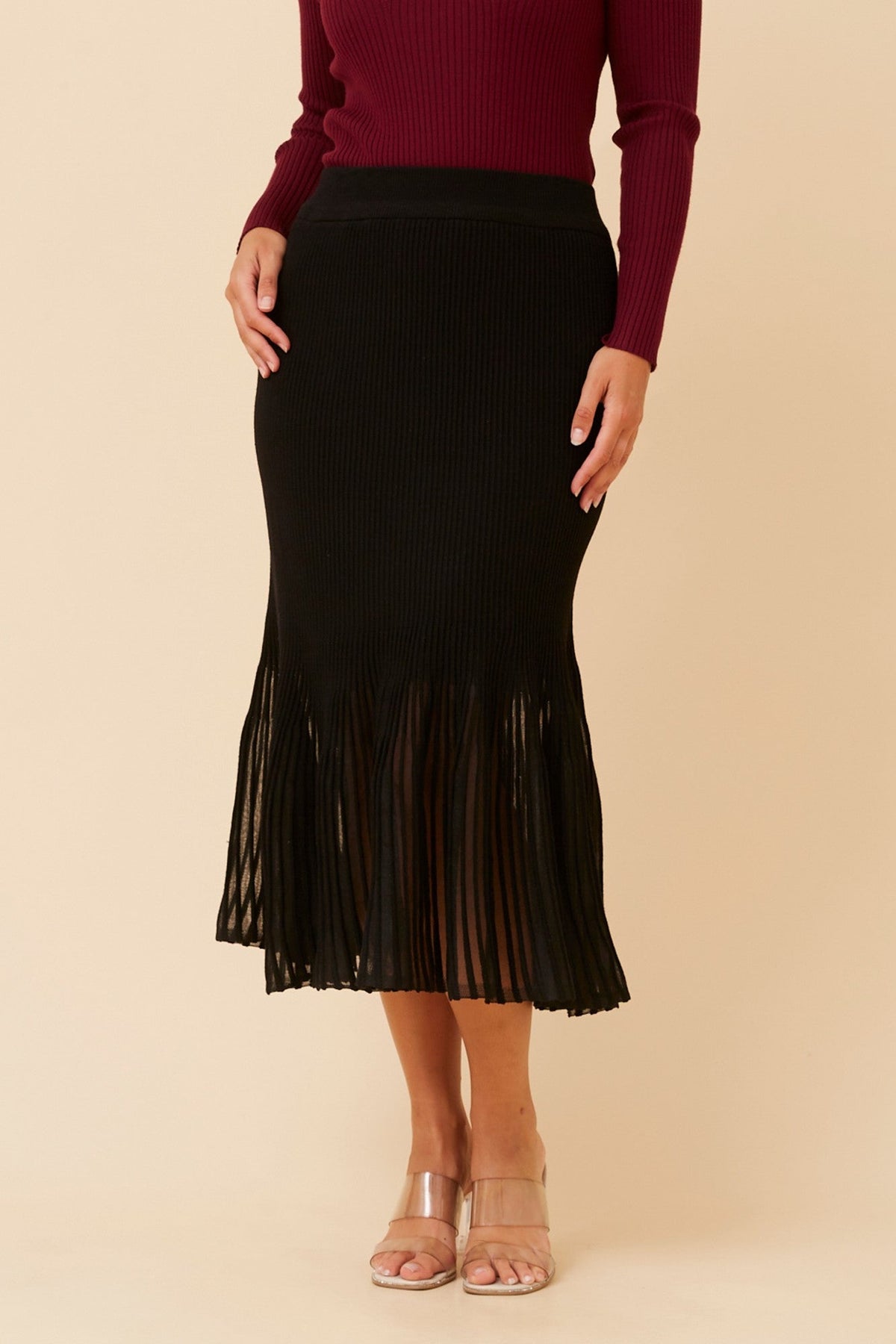 Image of a model wearing Skirts. Product name - GERDY WOOL BLEND MIDI SKIRT in Black colour by brand - Caroline Morgan Australia