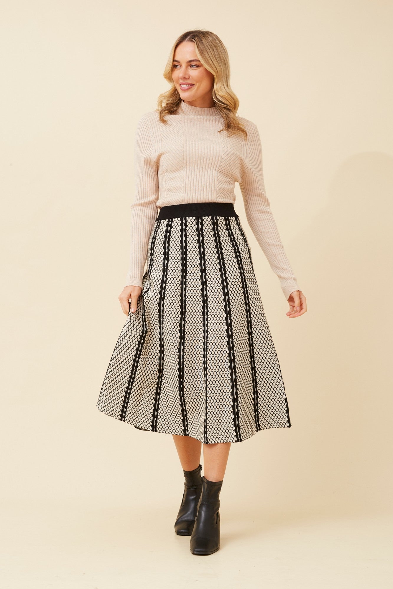 Image of a model wearing Skirts. Product name - ISA A-LINE KNIT SKIRT in Black colour by brand - Caroline Morgan Australia