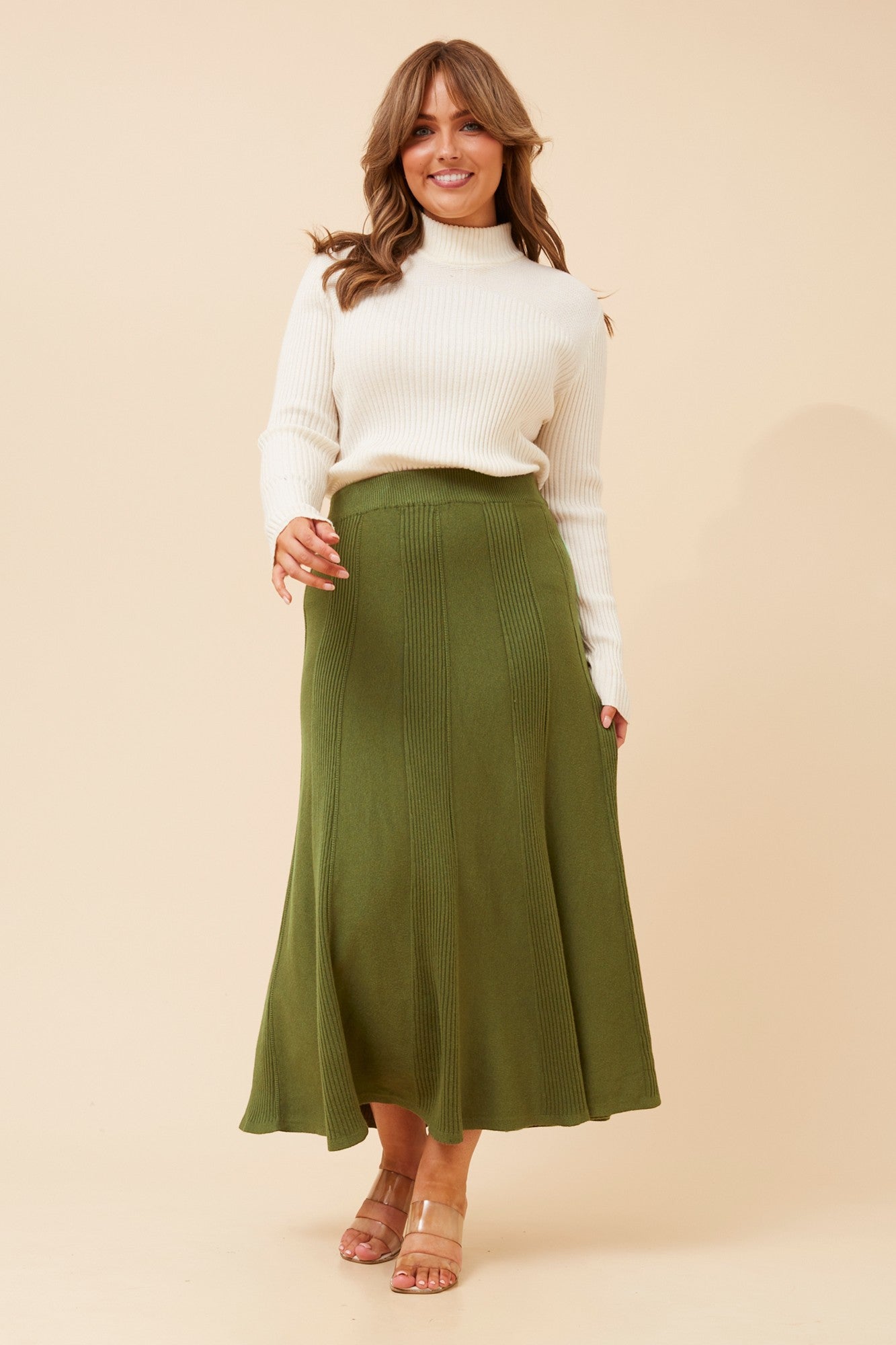 Image of a model wearing Skirts. Product name - ZUKI SOLID KNIT MAXI SKIRT in Khaki colour by brand - Caroline Morgan Australia