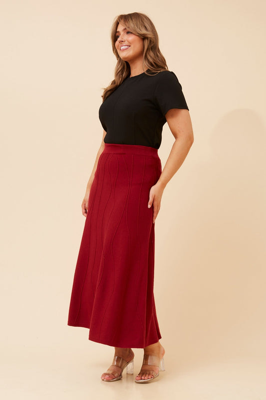 Image of a model wearing Skirts. Product name - ZORI A-LINE KNIT MAXI SKIRT in Wine colour by brand - Caroline Morgan Australia
