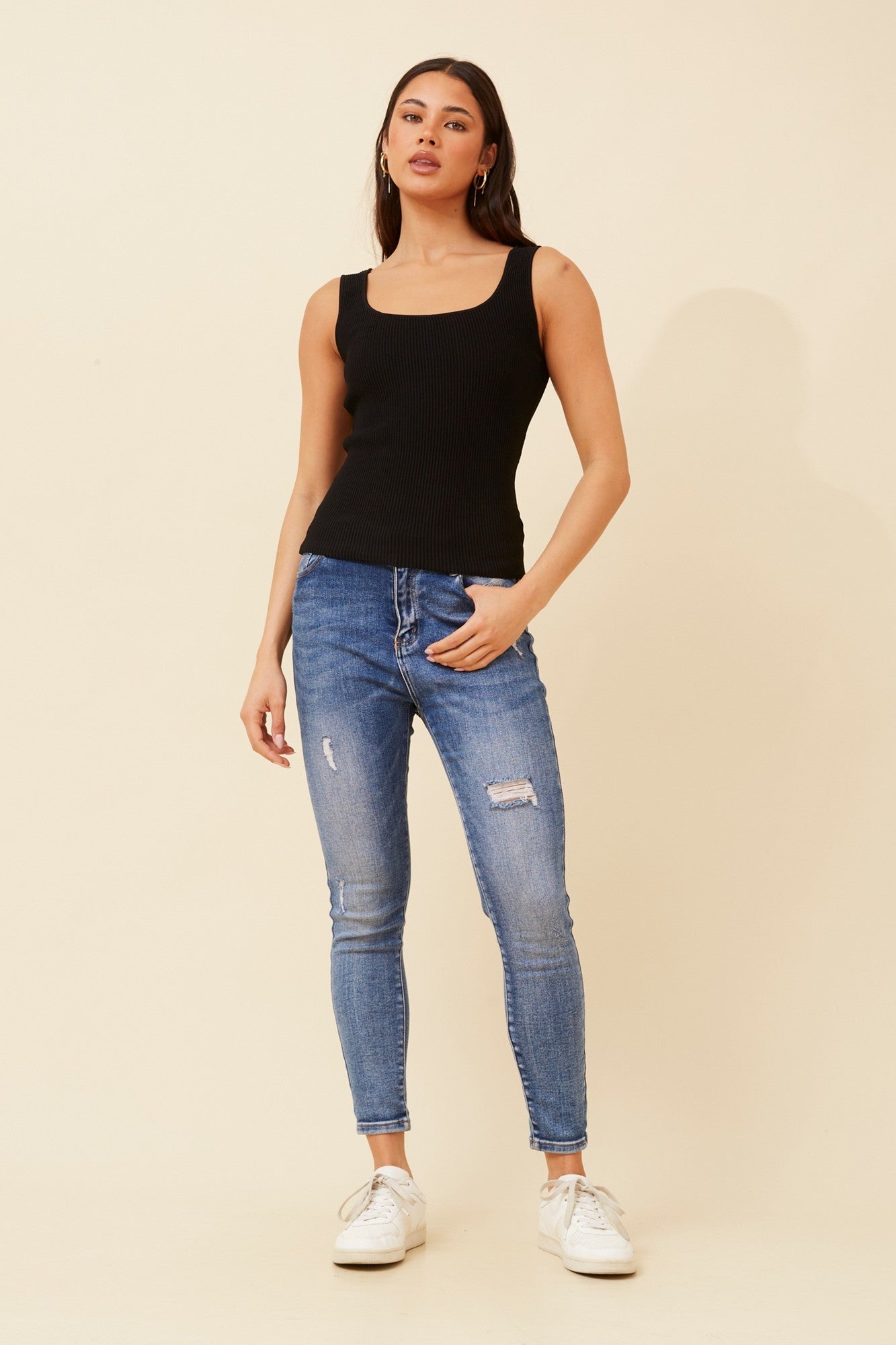 Image of a model wearing Tops. Product name - KIENNA SLEEVELESS KNIT TOP in Black colour by brand - Caroline Morgan Australia