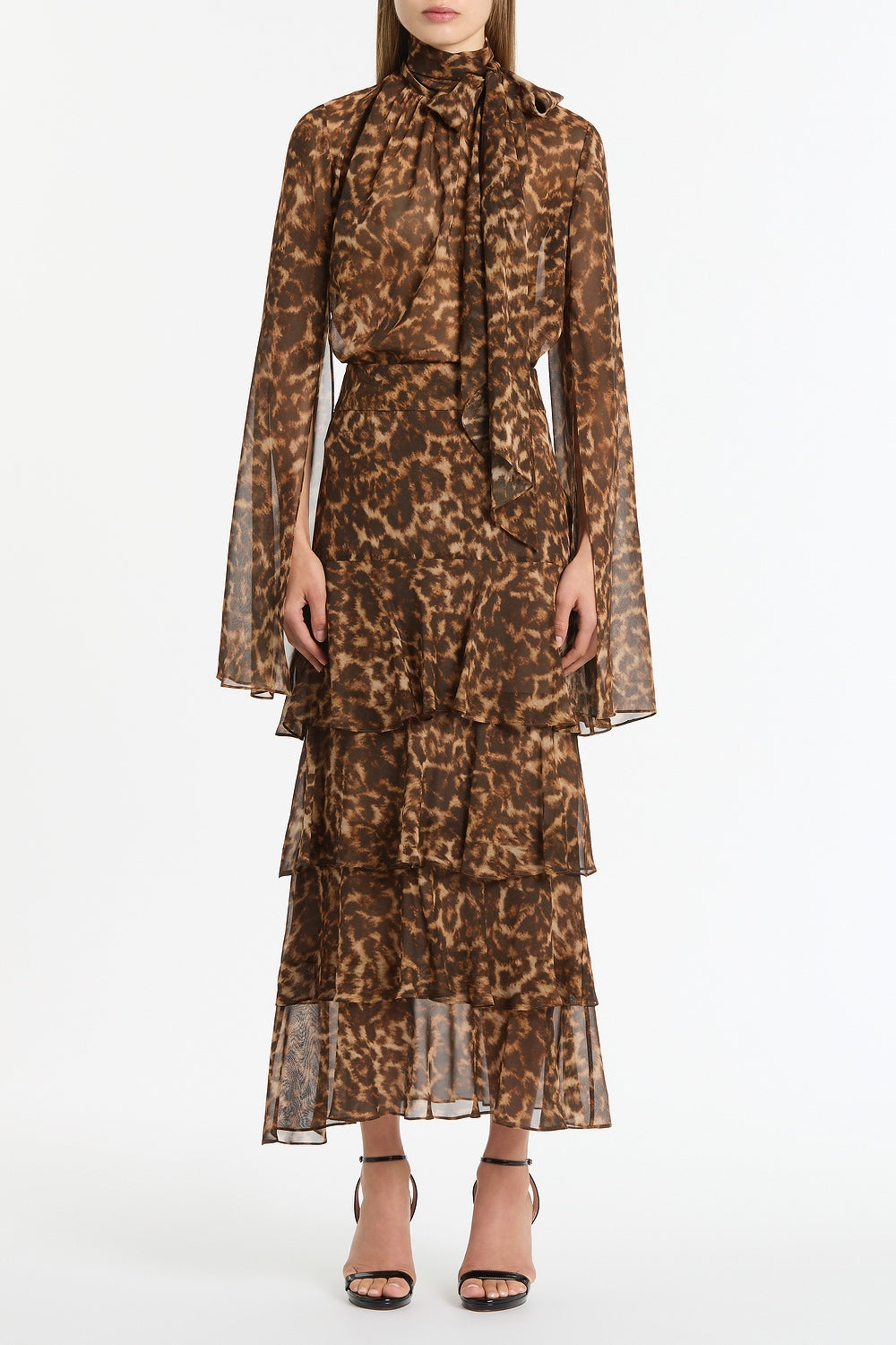Image of a model wearing Skirts. Product name - Leopard Silk Tiered Maxi Skirt in Brown colour by brand - Carla Zampatti