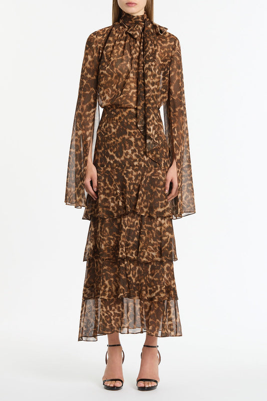 Image of a model wearing Skirts. Product name - Leopard Silk Tiered Maxi Skirt in Brown colour by brand - Carla Zampatti