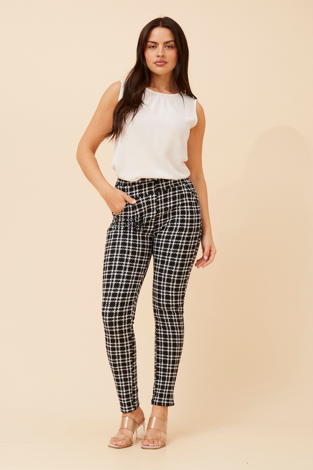 Image of a model wearing Pants. Product name - BELLEANNE CHECK PRINT LEGGINGS in Black/White colour by brand - Caroline Morgan Australia