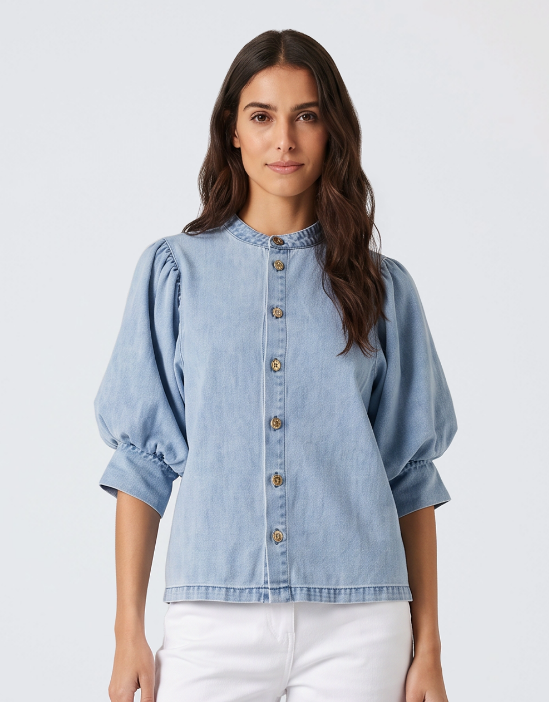 Image of a model wearing Tops. Product name - Lila Denim Balloon Shirt Light Wash in Blue colour by brand - Fate and Becker