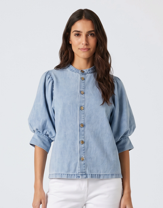 Image of a model wearing Tops. Product name - Lila Denim Balloon Shirt Light Wash in Blue colour by brand - Fate and Becker