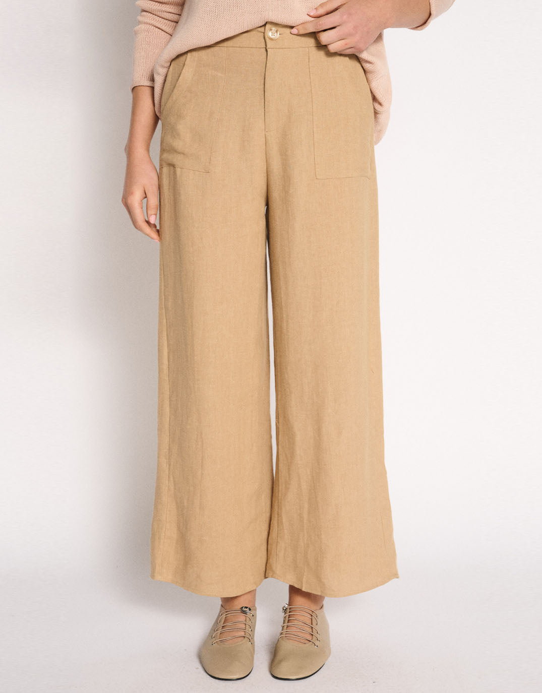 Image of a model wearing Pants. Product name - Jude Wide Leg Linen Pant Camel in Camel colour by brand - Little Lies