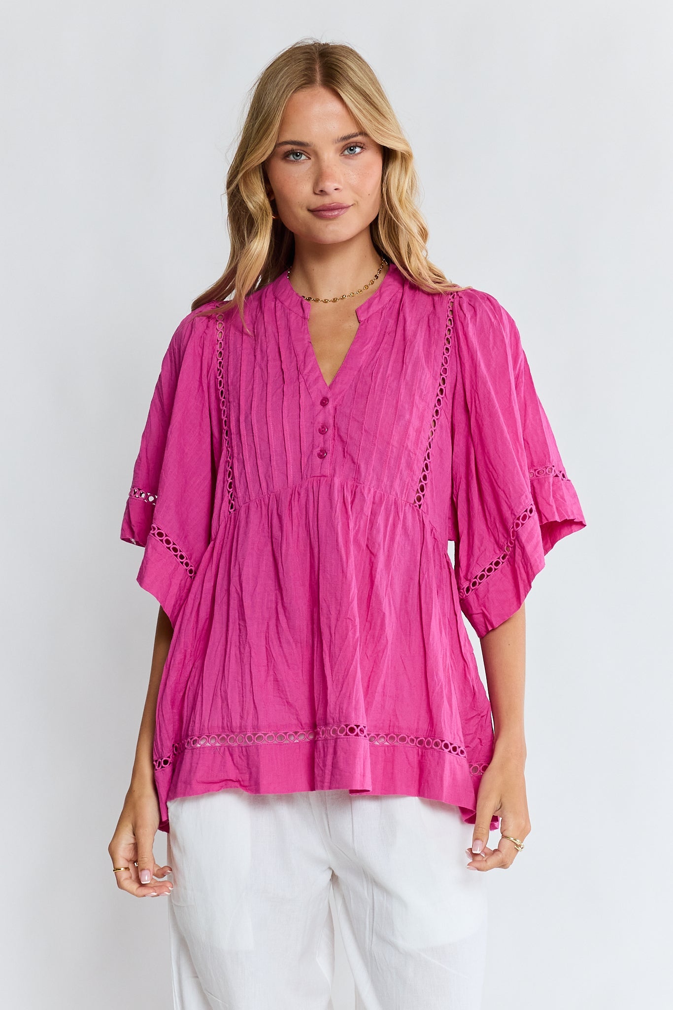 Image of a model wearing Tops. Product name - LulaLife Laverne Pintuck Top Fuschia in Fuschia colour by brand - Lulalife