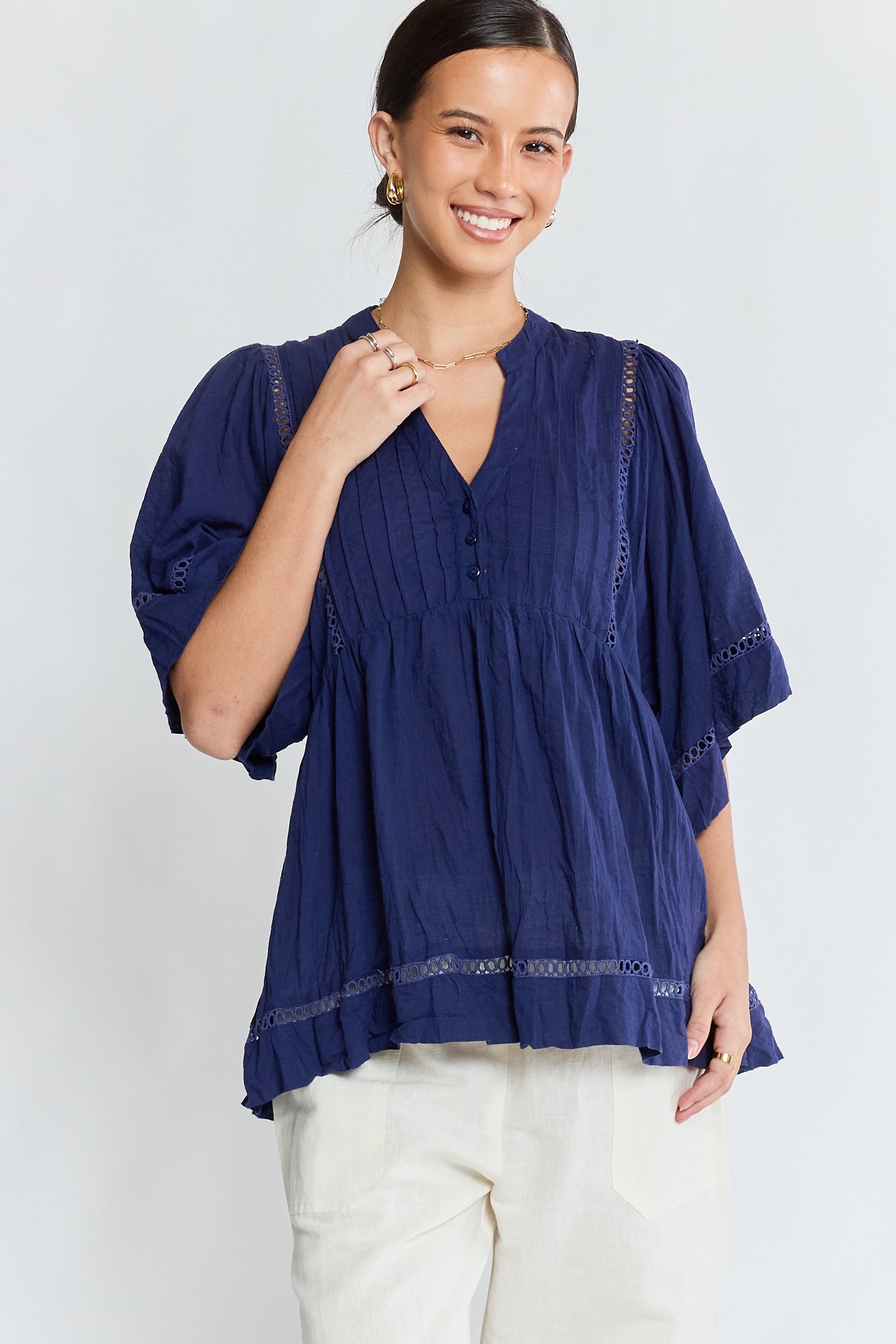 Image of a model wearing Tops. Product name - LulaLife Laverne Pintuck Top Navy in Navy colour by brand - Lulalife