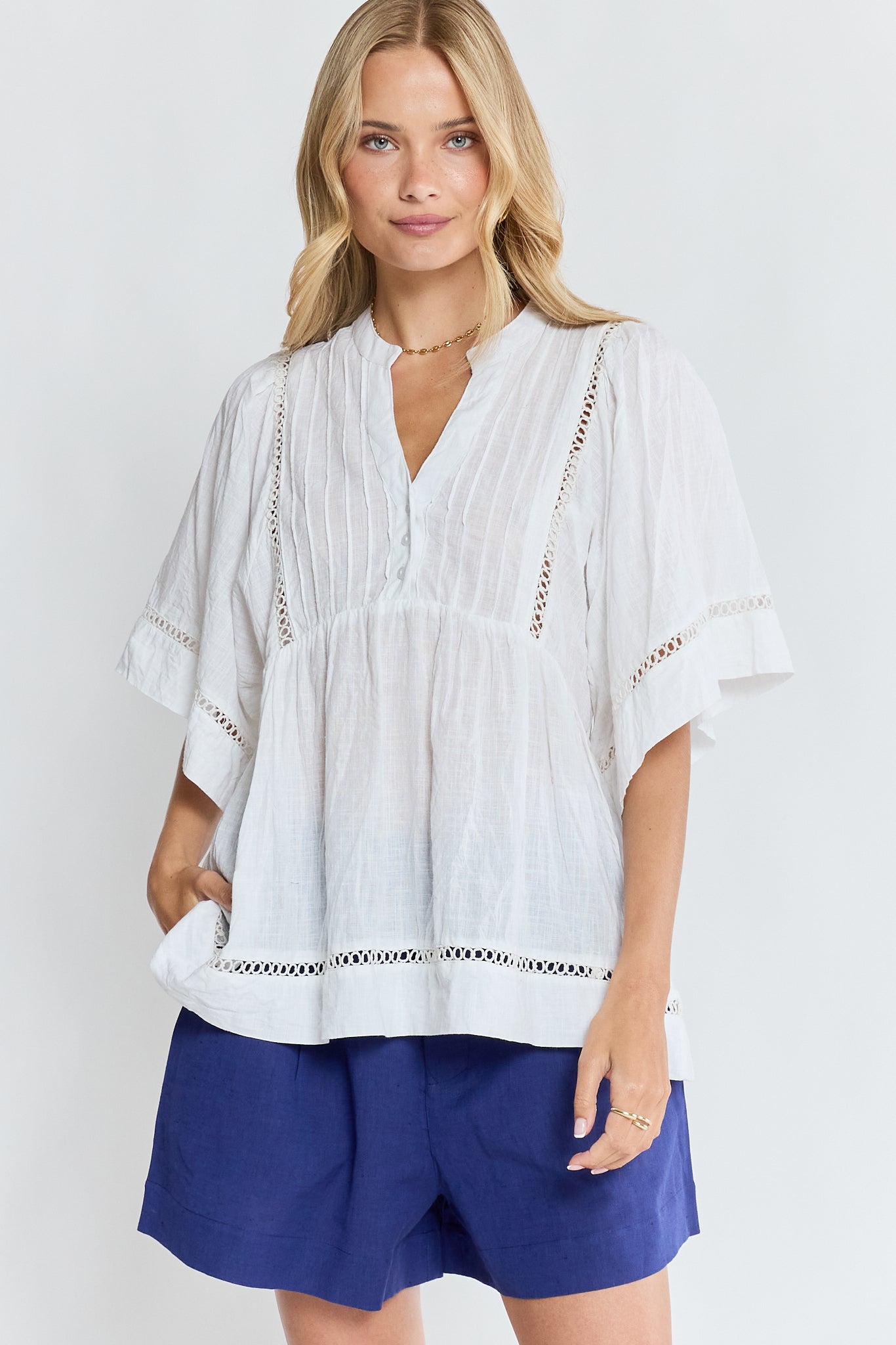 Image of a model wearing Tops. Product name - LulaLife Laverne Pintuck Top White in White colour by brand - Lulalife