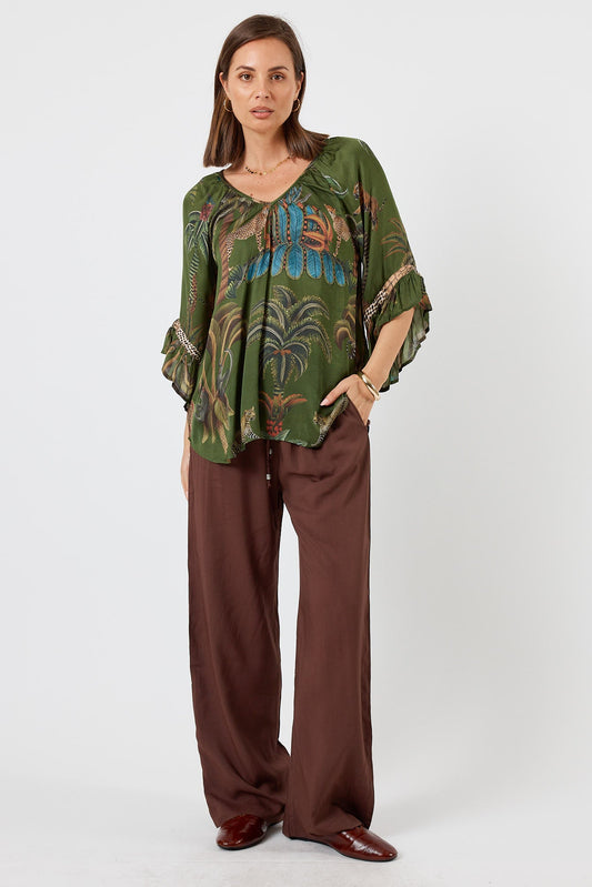 Image of a model wearing Tops. Product name - LulaSoul Cheetah Top Olive in Olive colour by brand - LulaSoul