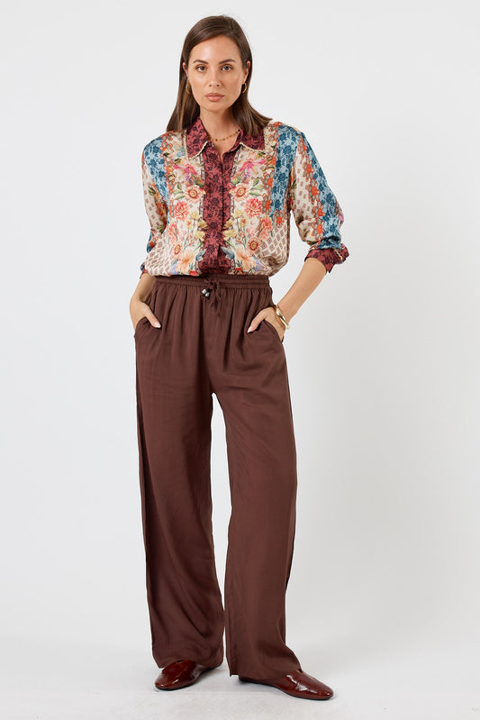 Image of a model wearing Pants. Product name - LulaSoul Delta Pant Espresso in Espresso colour by brand - LulaSoul