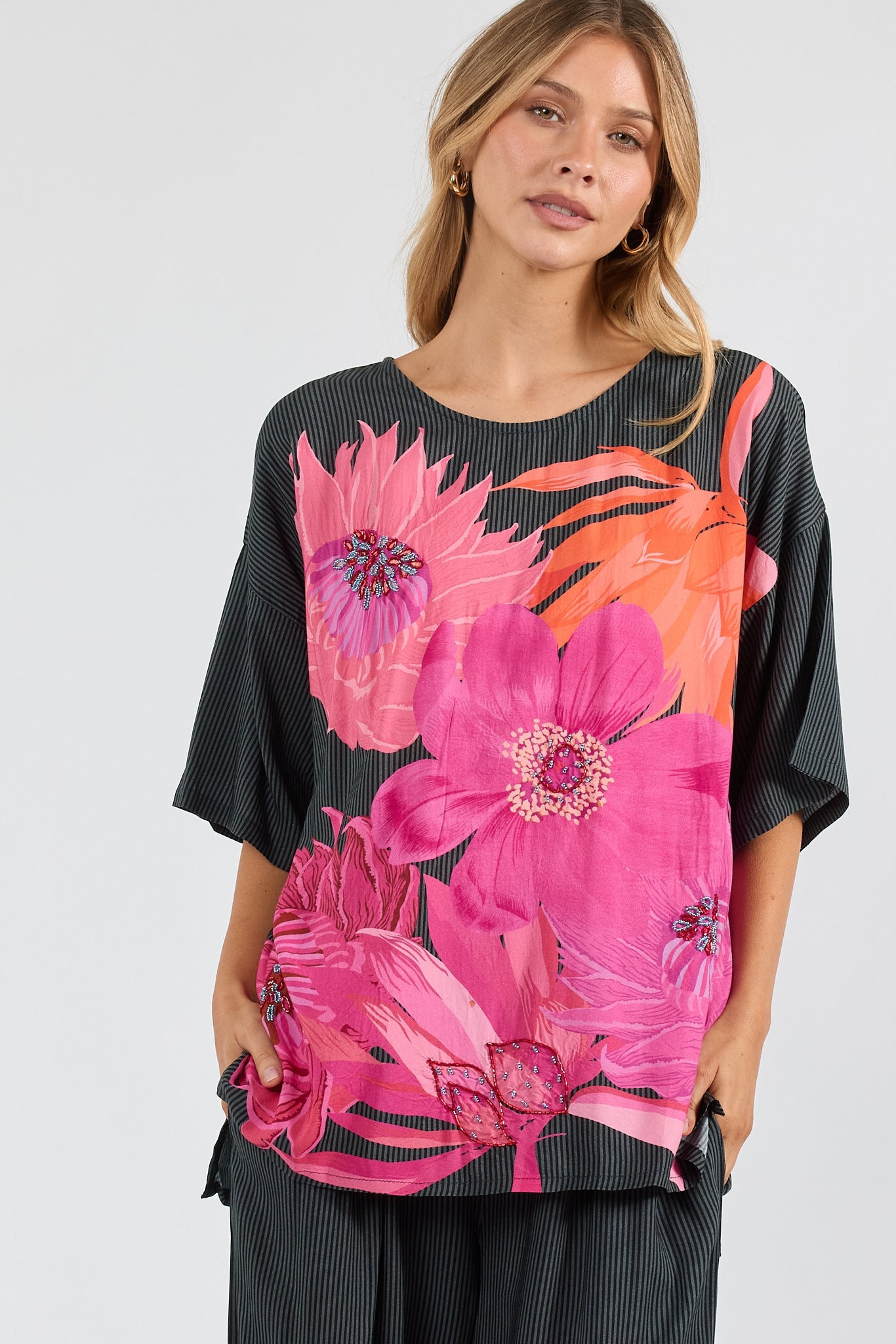 Image of a model wearing Tops. Product name - PRE SALE | LulaSoul Hana Wide T Black in Black colour by brand - Lulasoul