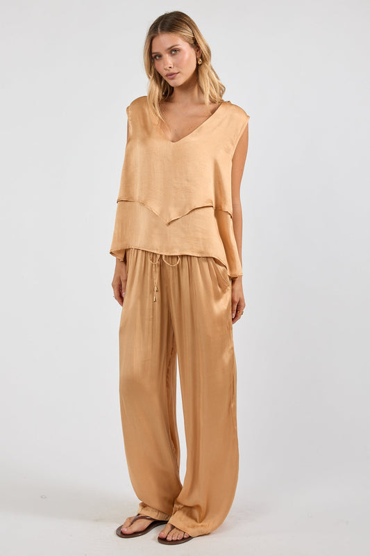 Image of a model wearing Pants. Product name - LulaSoul Venita Pant Latte in Latte colour by brand - Lulasoul