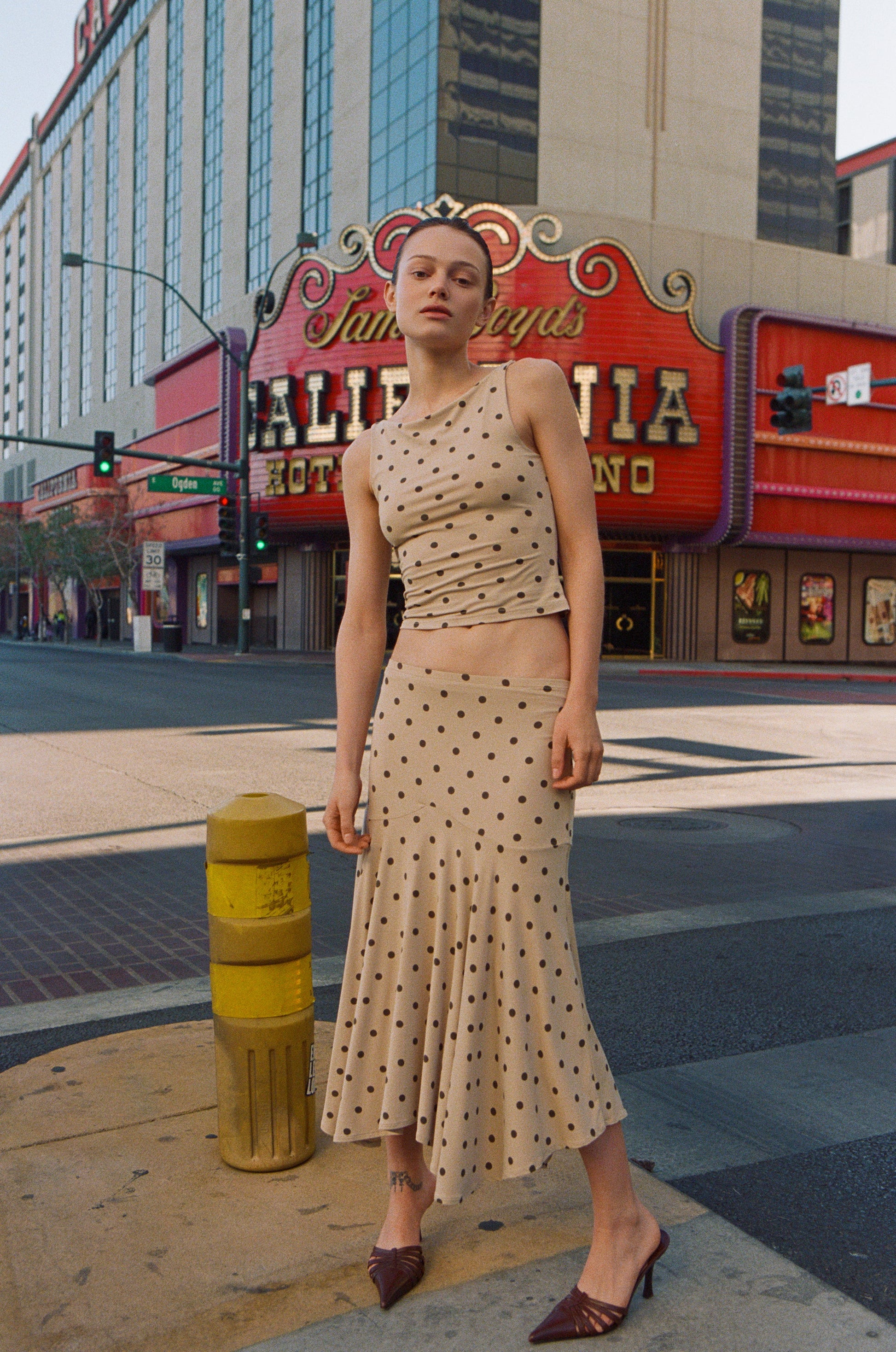 Image of a model wearing Skirts. Product name - Maeve Midi Skirt in Polka Dot colour by brand - With Jéan