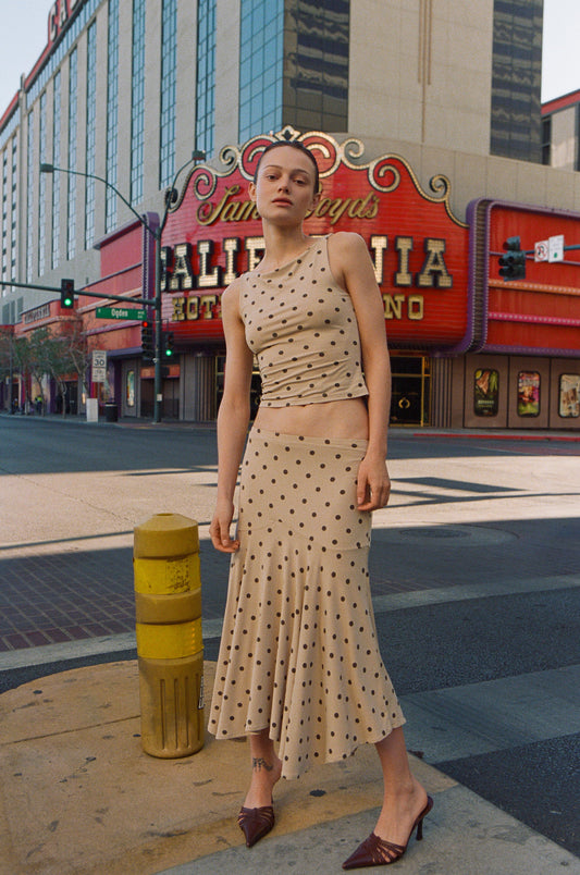 Image of a model wearing Skirts. Product name - Maeve Midi Skirt in Polka Dot colour by brand - With Jéan