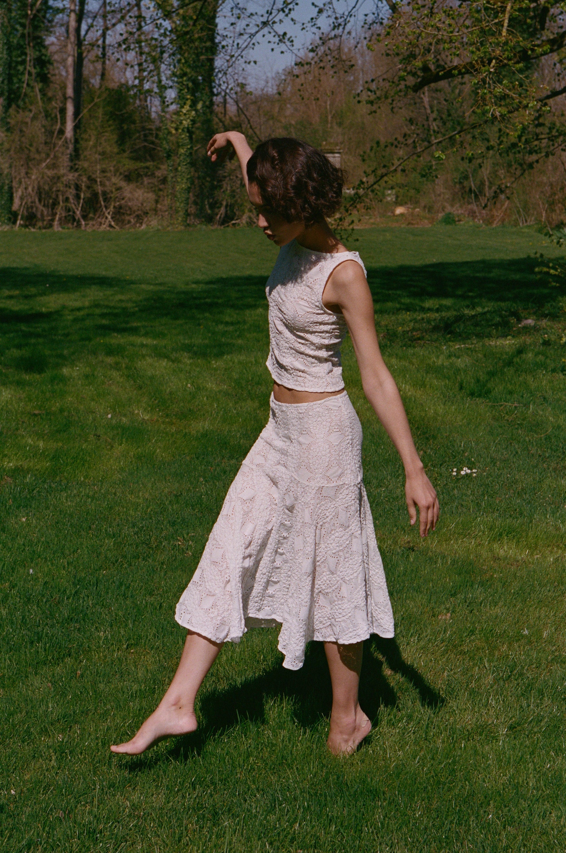 Image of a model wearing Skirts. Product name - Maeve Midi Skirt in White colour by brand - With Jéan