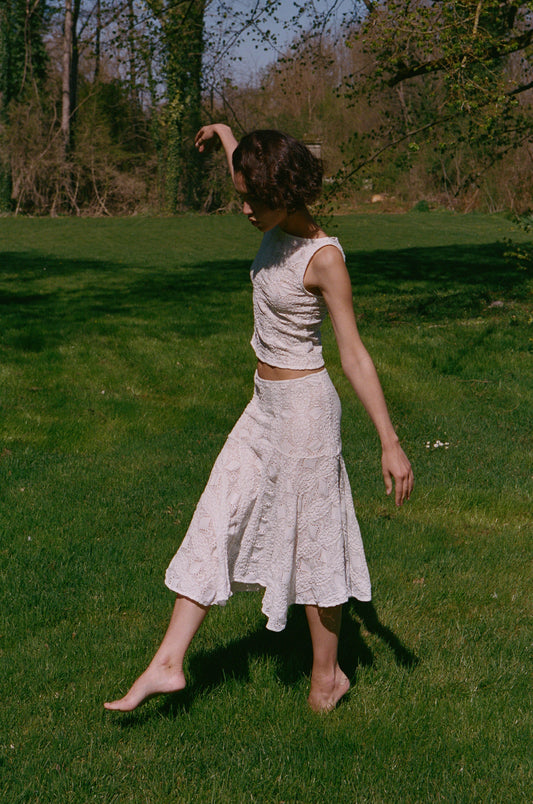 Image of a model wearing Skirts. Product name - Maeve Midi Skirt in White colour by brand - With Jéan
