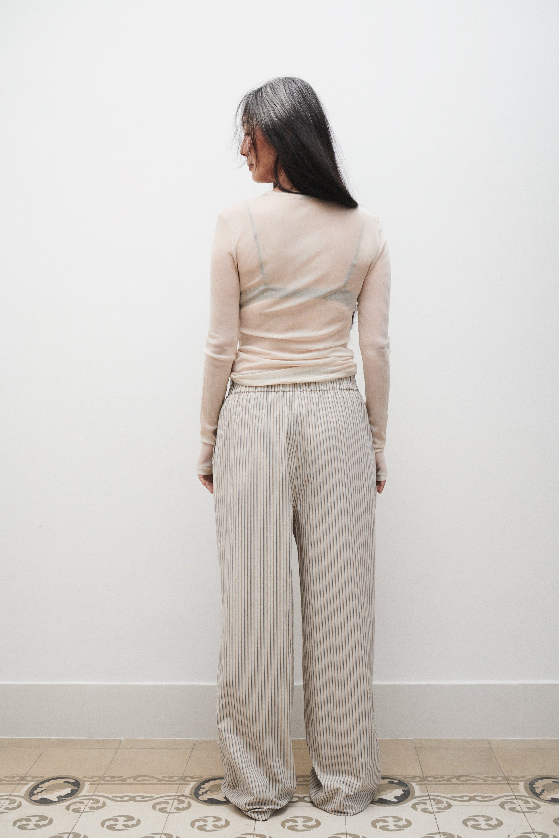 Image of a model wearing Pants. Product name - Cotton Paper Bag Pants Slate Stripe in Slate Stripe colour by brand - Silk Laundry