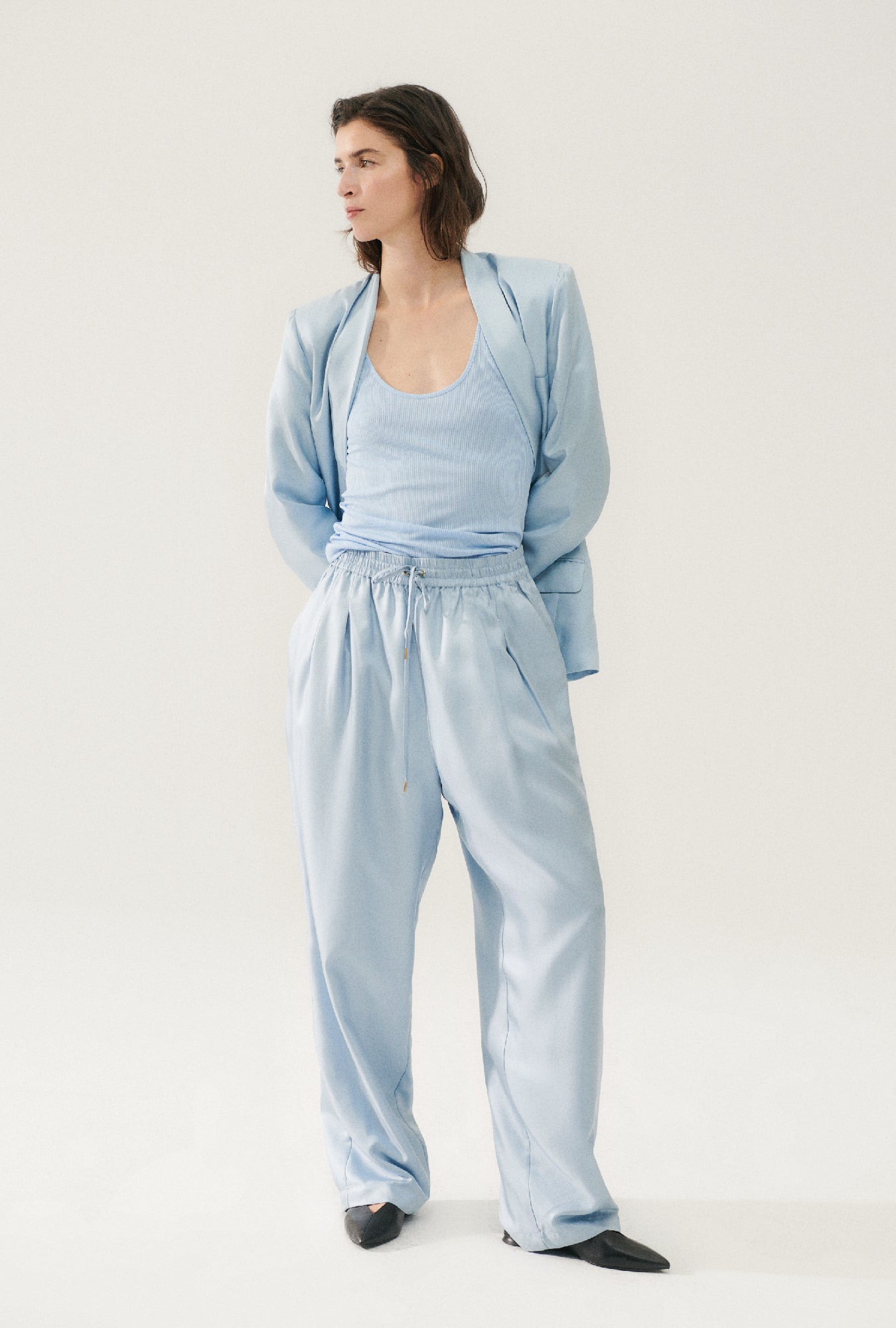 Image of a model wearing Pants. Product name - Twill Slouch Pants Sky in Sky colour by brand - Silk Laundry