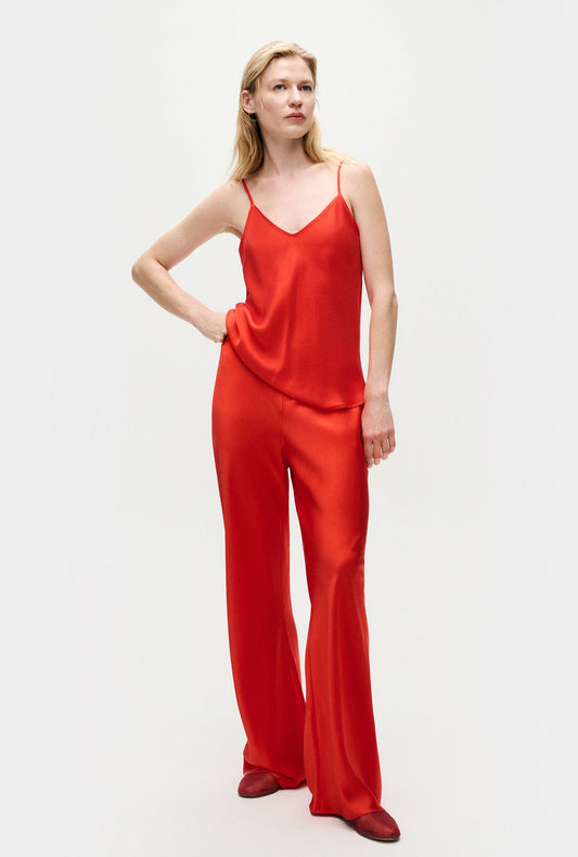 Image of a model wearing Pants. Product name - Bias Cut Pants Geranium in Geranium colour by brand - Silk Laundry