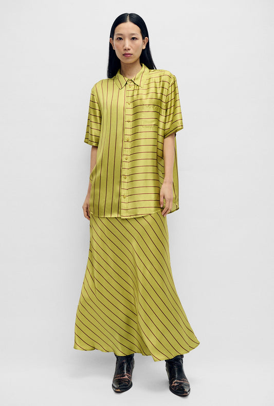 Image of a model wearing Skirts. Product name - Long Bias Cut Skirt Cactus Stripe in Cactus Stripe colour by brand - Silk Laundry