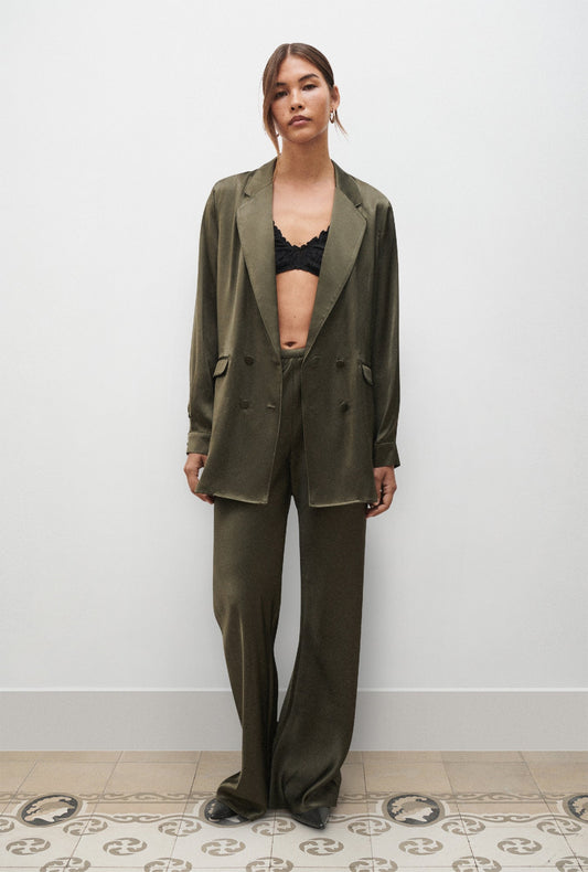 Image of a model wearing Pants. Product name - Bias Cut Pants Pine in Pine colour by brand - Silk Laundry