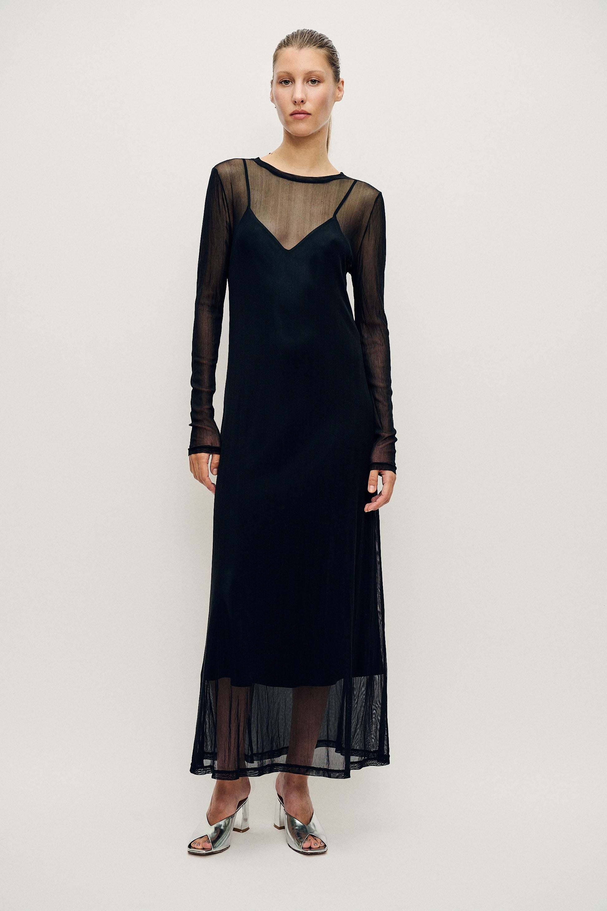 Image of a model wearing Tops. Product name - Mesh Long Sleeve Dress Black in Black colour by brand - Silk Laundry