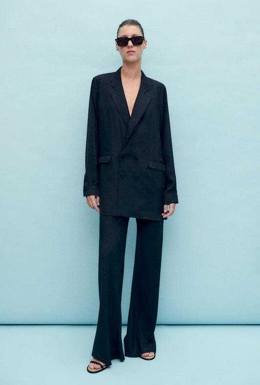 Image of a model wearing Pants. Productname: Bias Cut Pants Coral Jacquard in Coral Jacquard colour by brand - Silk Laundry