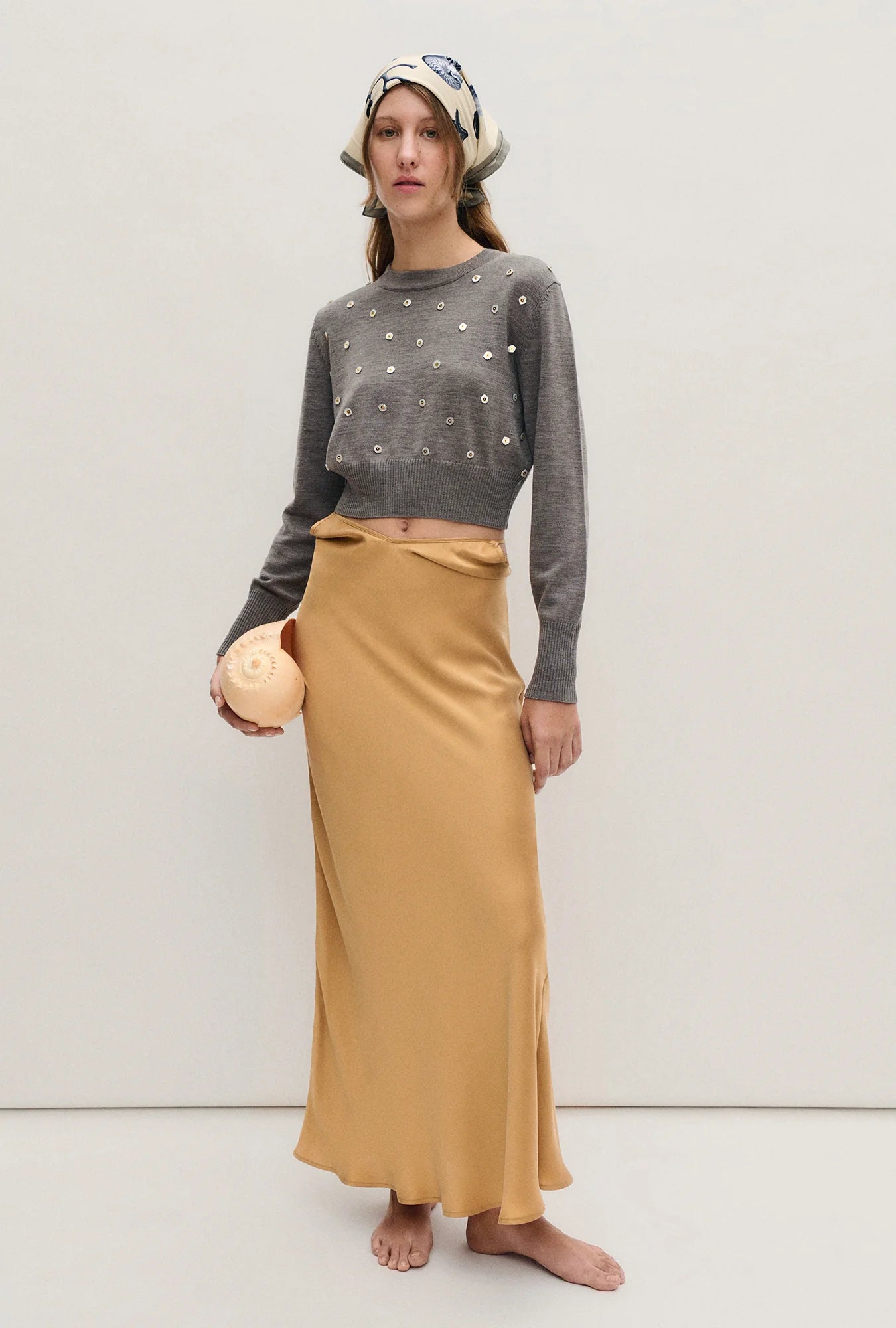 Image of a model wearing Outerwear. Product name - Cropped Crewneck Pearl in Pearl colour by brand - Silk Laundry