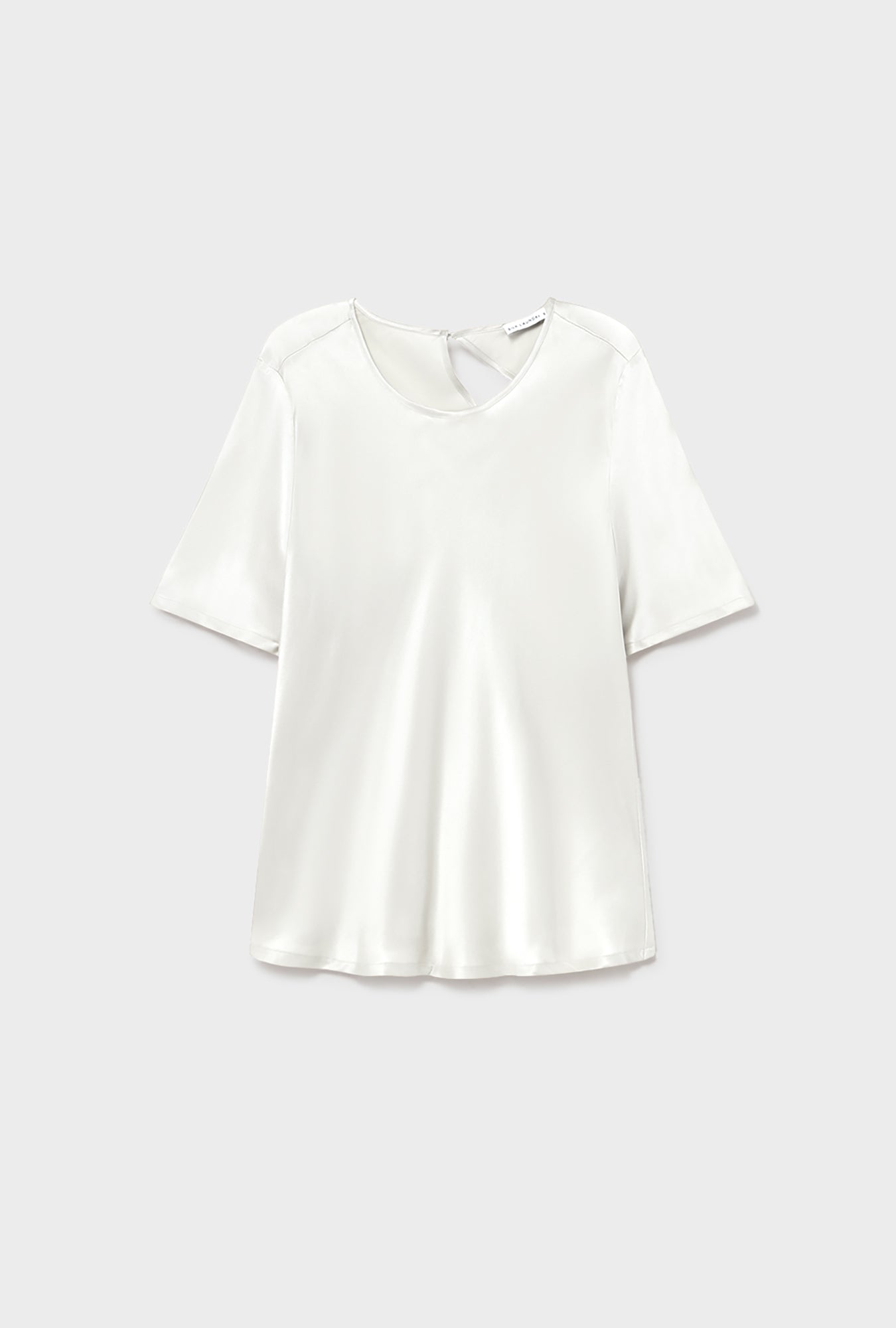 Image of a model wearing Tops. Product name - Short Sleeve Bias Top White in White colour by brand - Silk Laundry